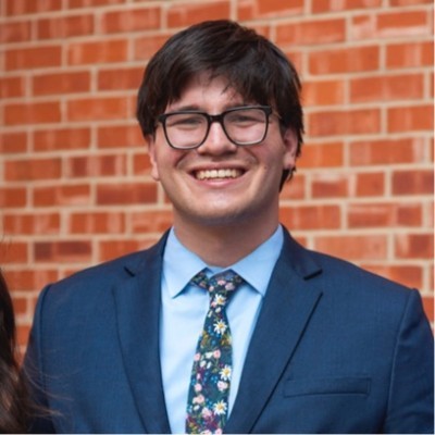 woman staring directly at camera near pink wall