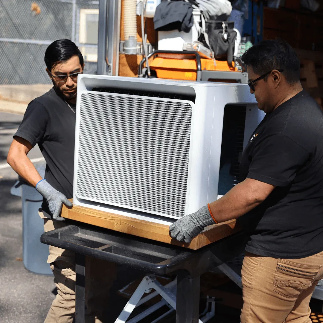 Gradient technicians assembling a window heat pump