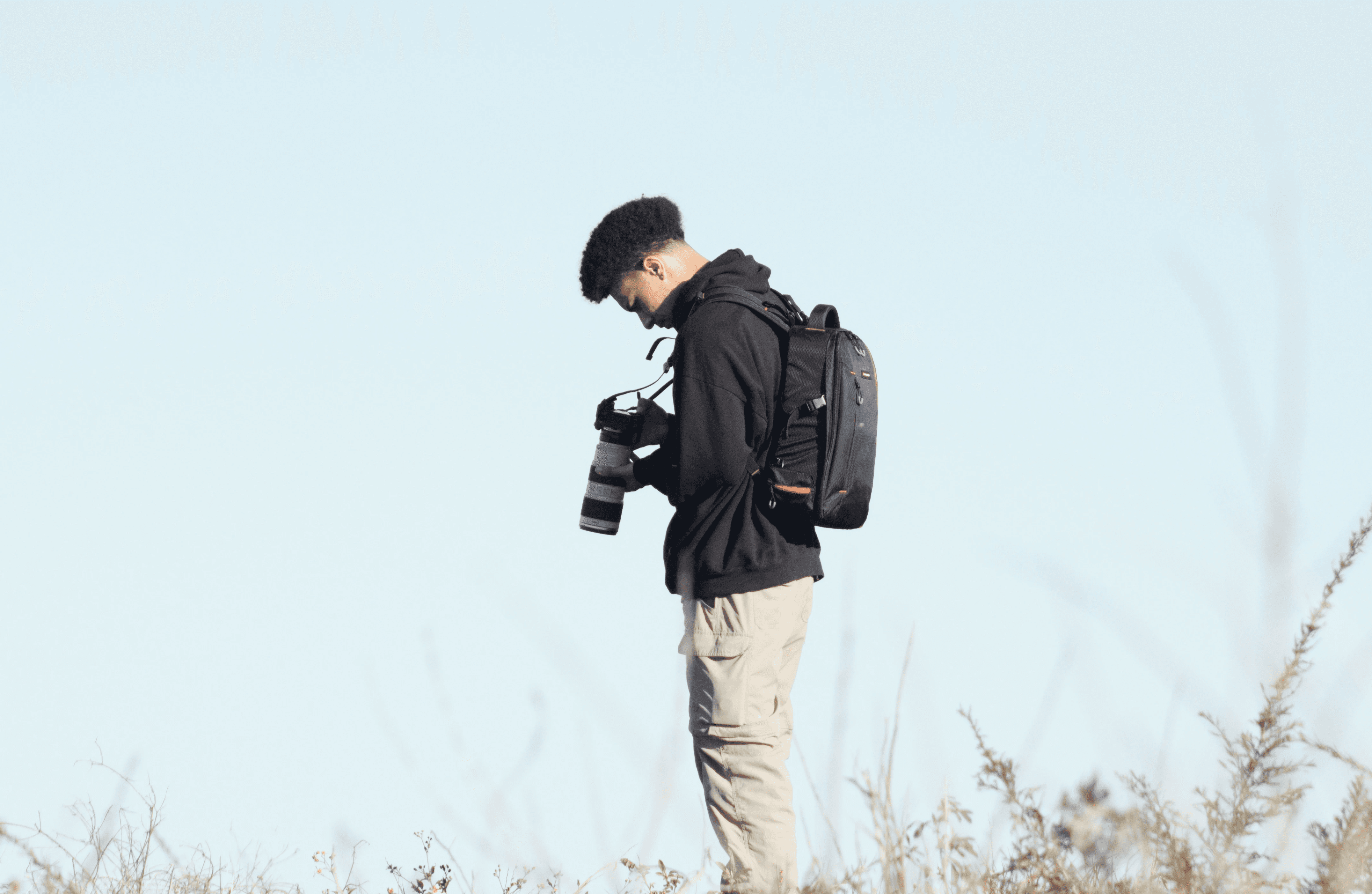 Timo Kisyeri standing and looking down at a camera screen