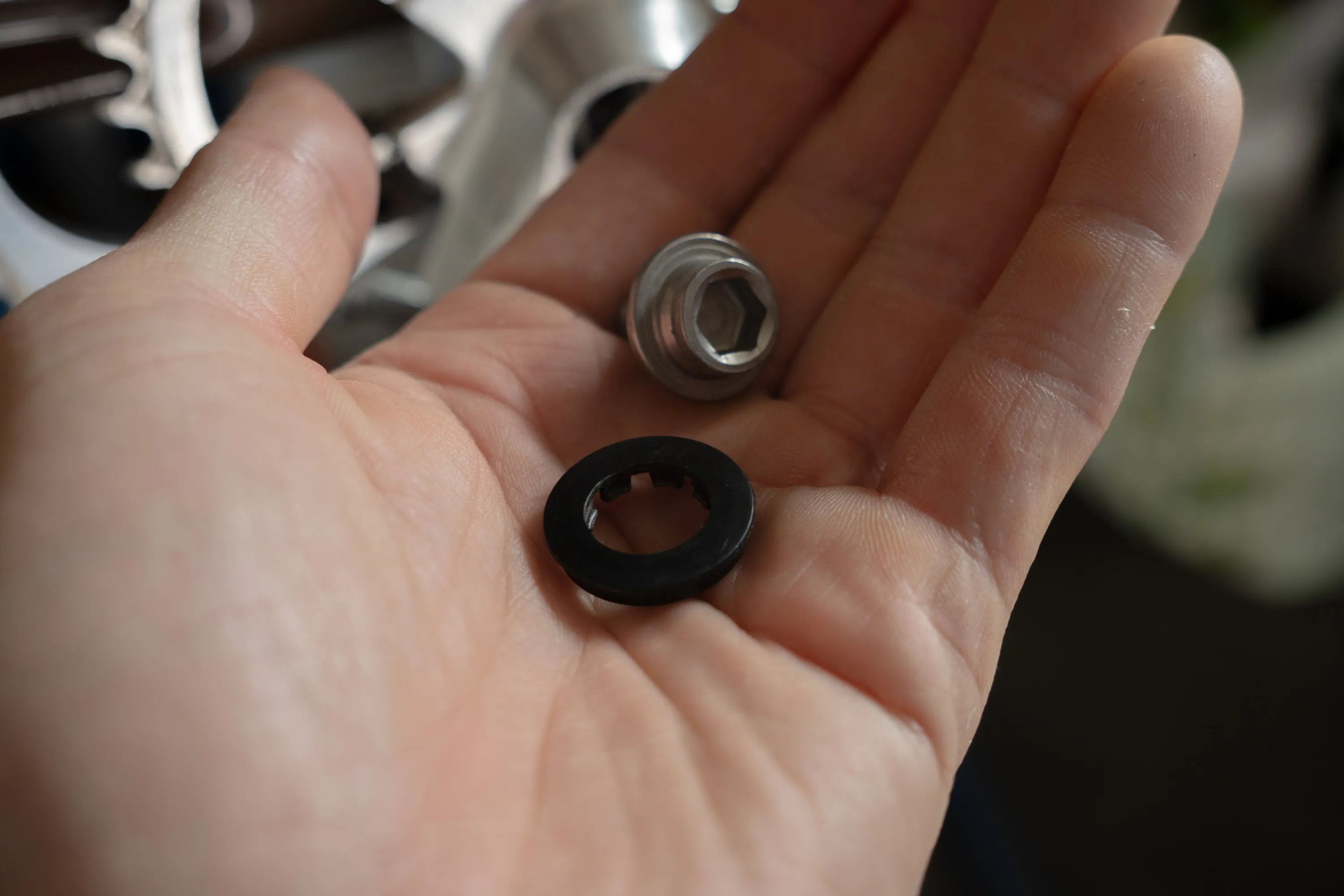 A close up of a person working on a bike crankset