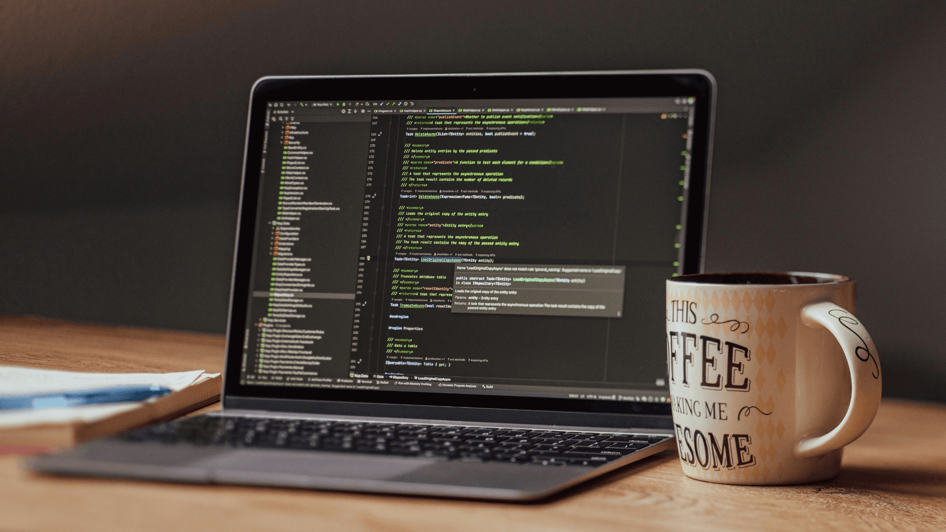 Computer showing code platform, cup of coffe on the side | IDIGIU