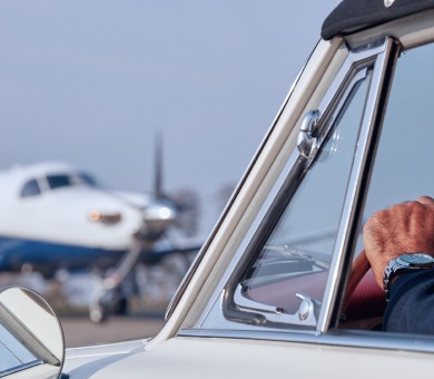 Client arriving at aircraft in car with Pilatus PC-12 on the tarmac