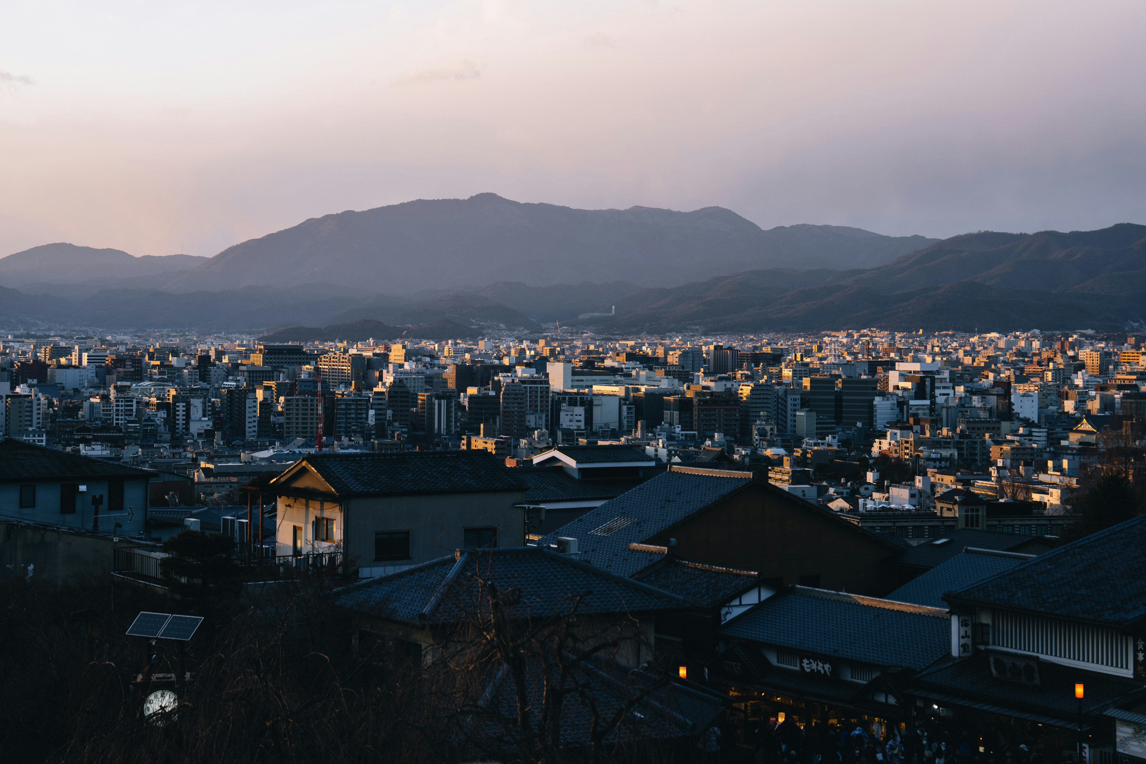 Scenic aerial view of a town with mountains in the background, captured at sunrise