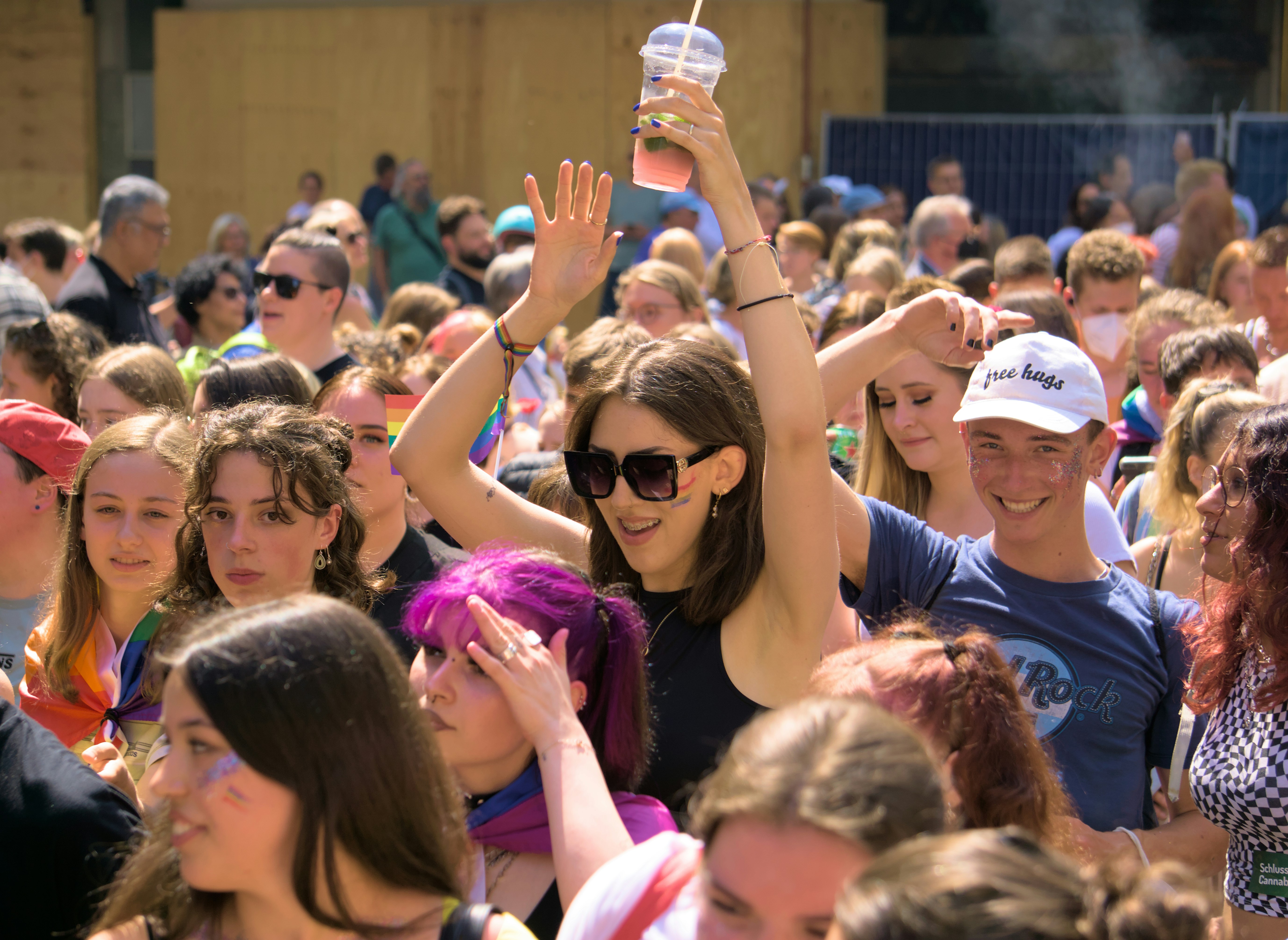 feminine-read person cheering in a crowd