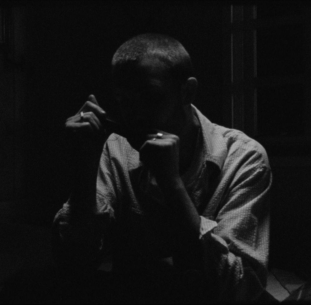 man in dark shadows artistic musician