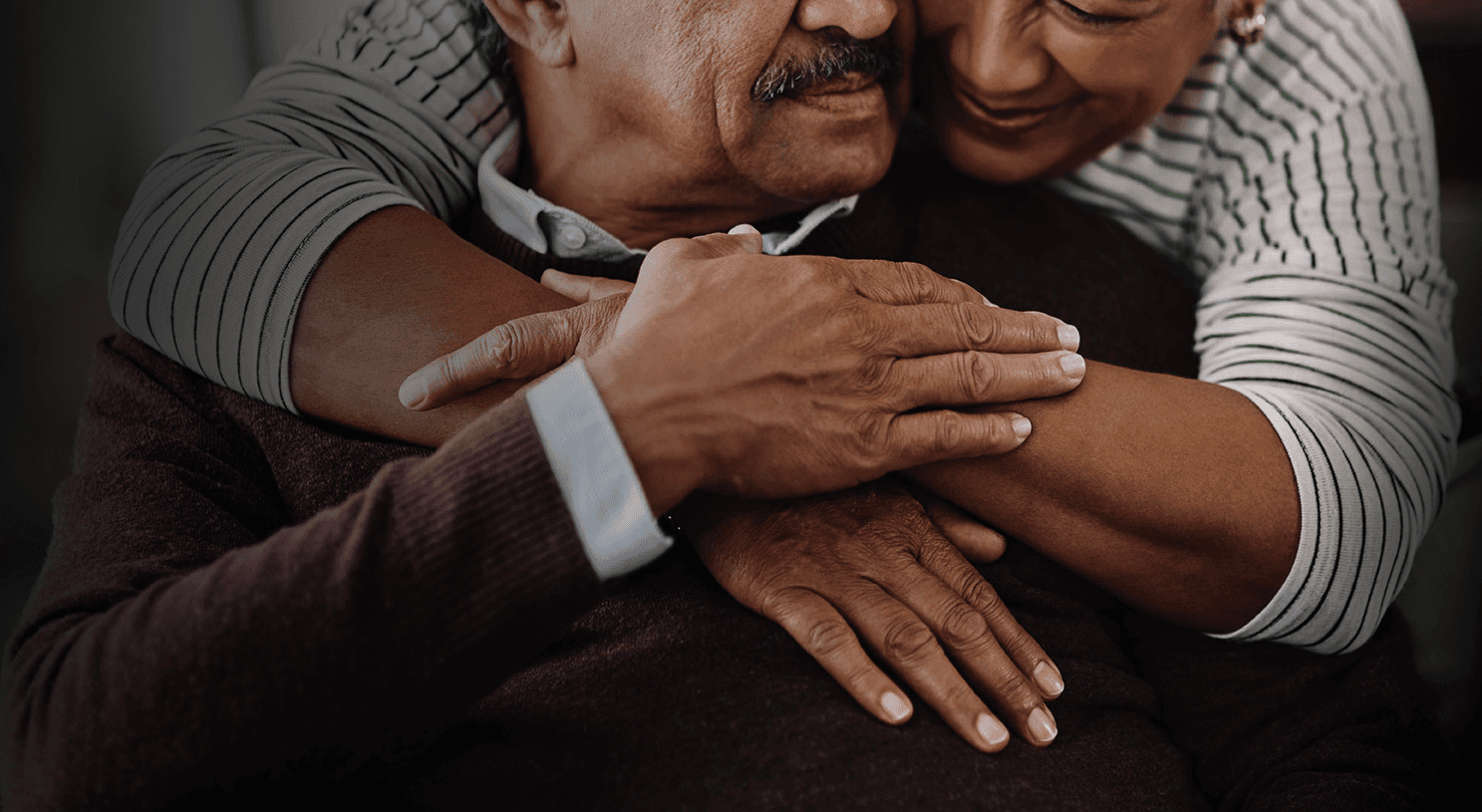 Close-up of older couple embracing