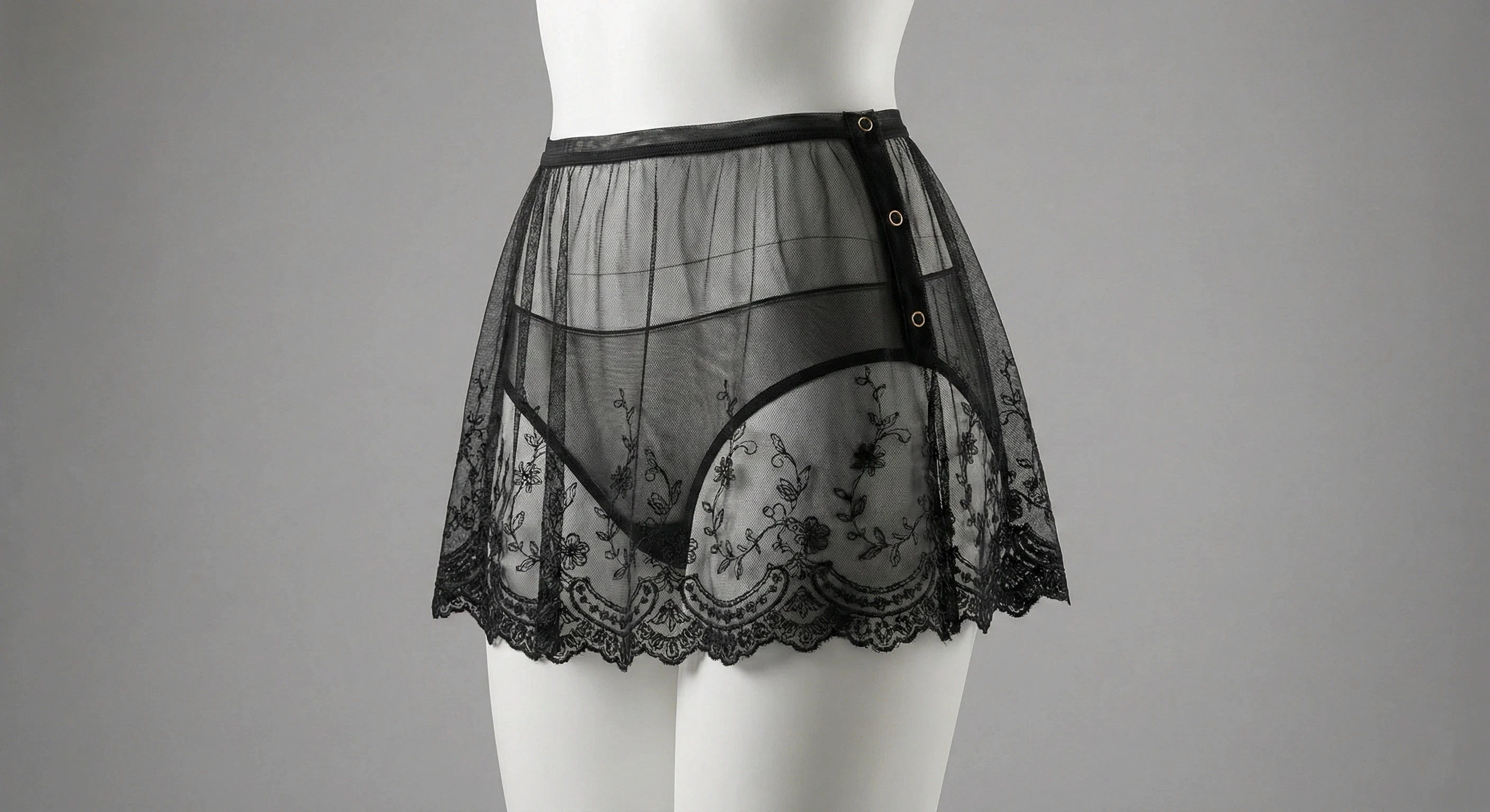 Close-up of a black lace bralette with scalloped edges and lace underband.