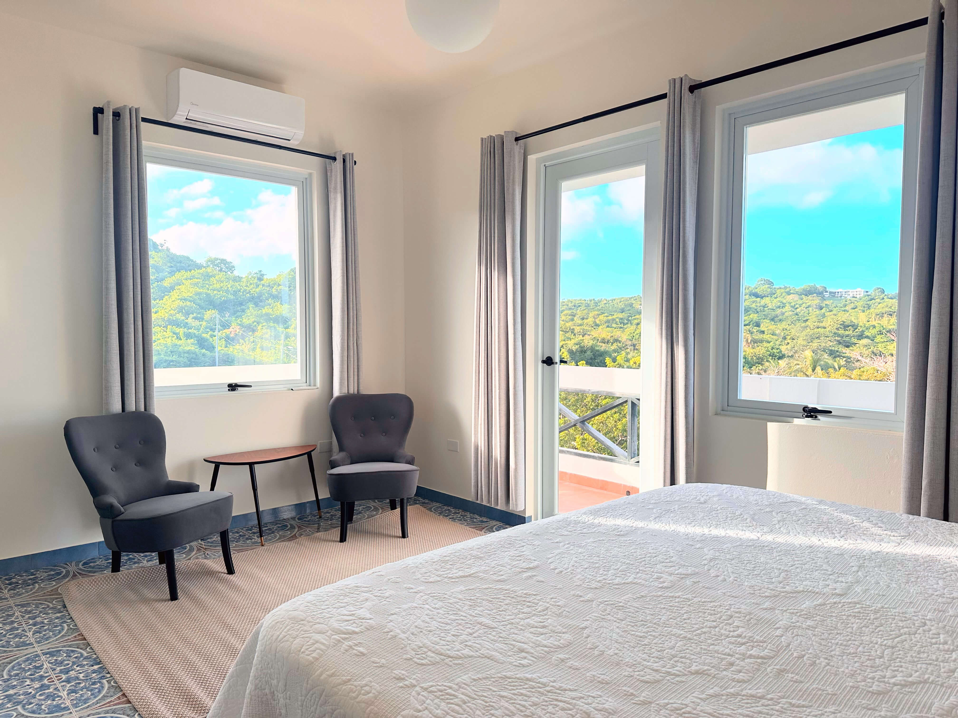 Seating area in Room 7 at Club Vieques with stylish chairs and table.