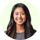 A woman with long hair smiles brightly inside a circular frame, radiating joy and positivity.