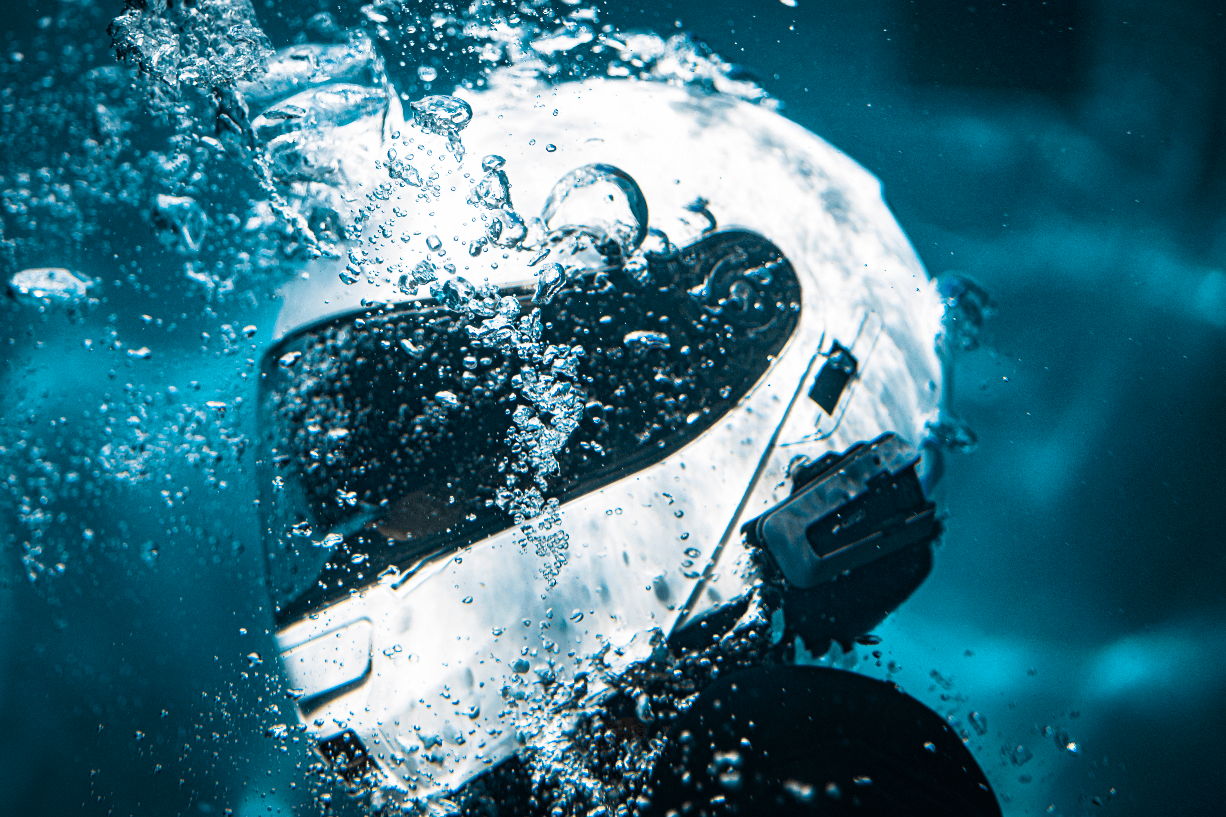 man divning into pool with a helmet on
