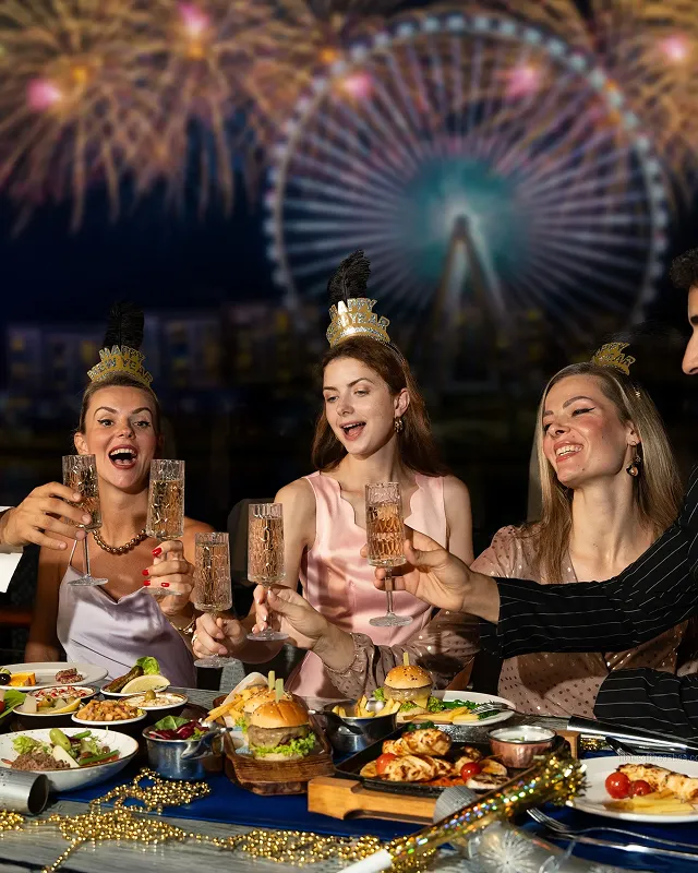 Palm trees frame a dramatic mountain valley landscape