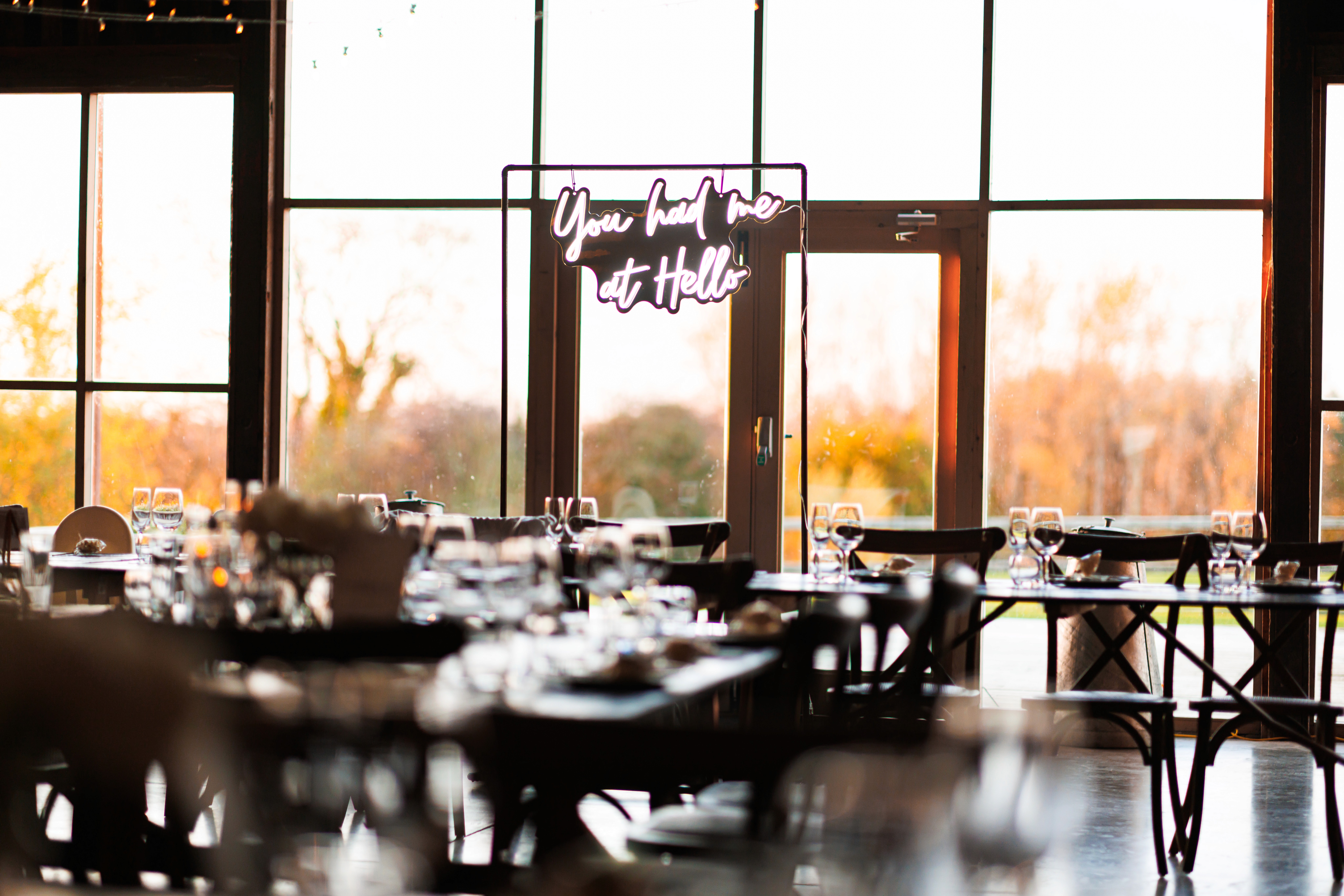 Grange Barn’s timber reception room with a You Had Me at Hello sign by the window