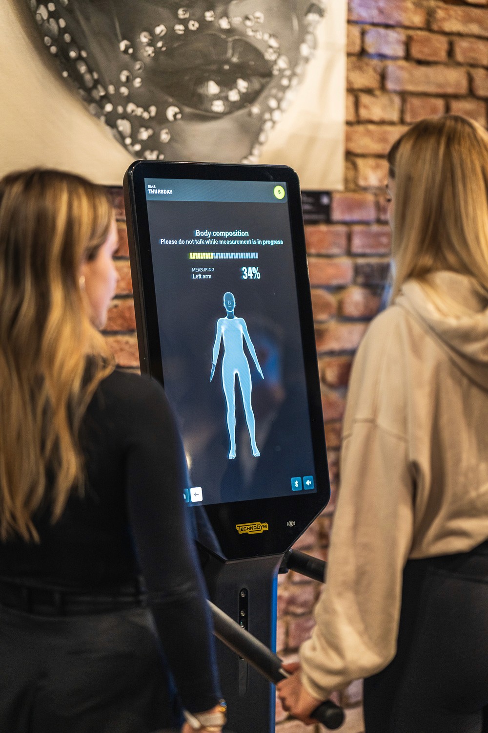 Attendees interacting with a digital health or technology display at a conference exhibition.