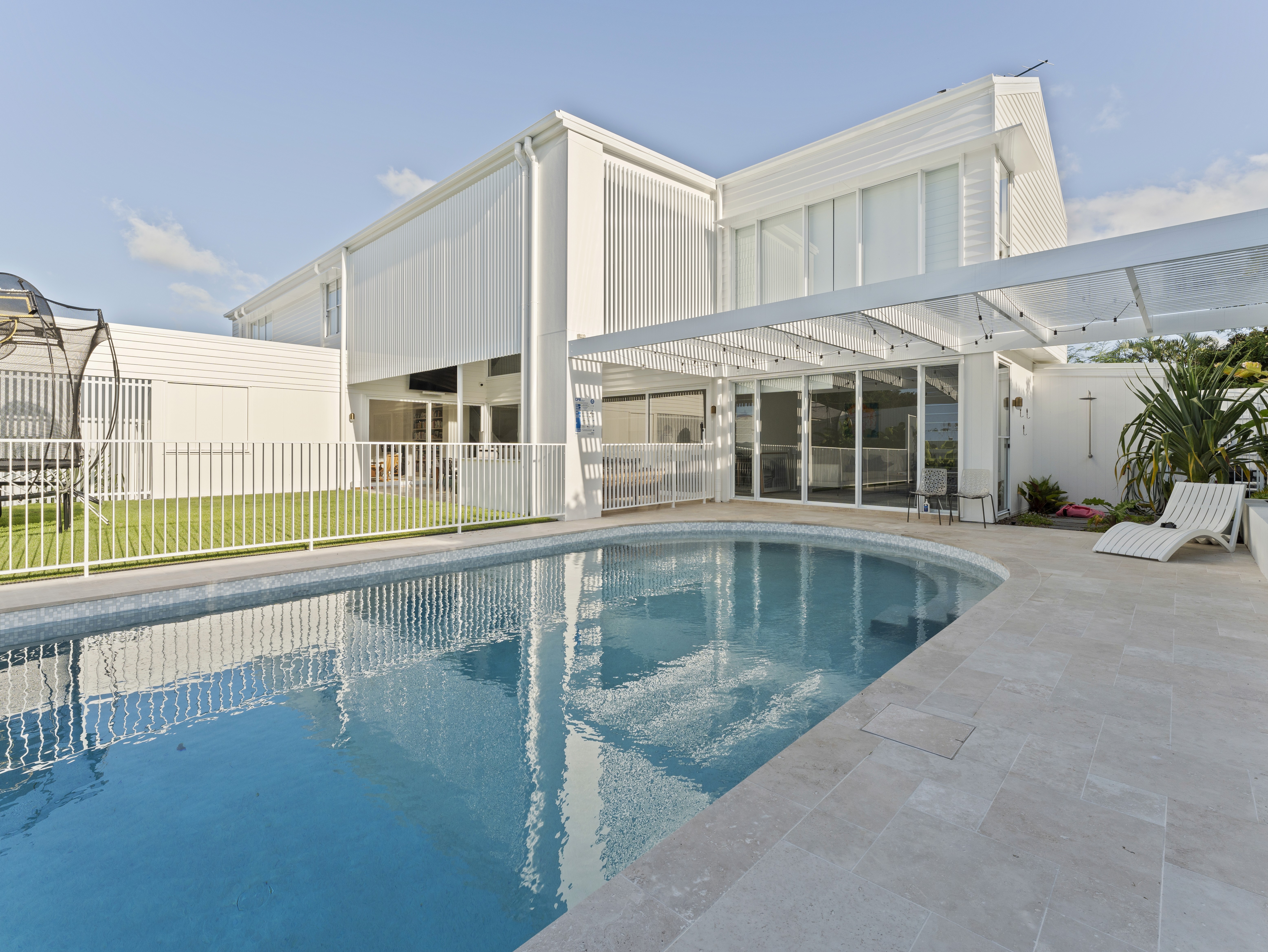A custom Brisbane home with a seamlessly integrated swimming pool, showcasing concurrent construction and coordinated site management.