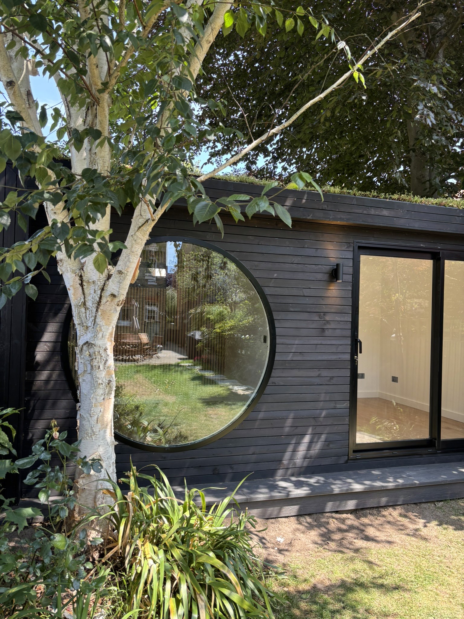 Circular Music Studio in Beckenham. Burnt Siberian larch garden room by Eleven Trees.