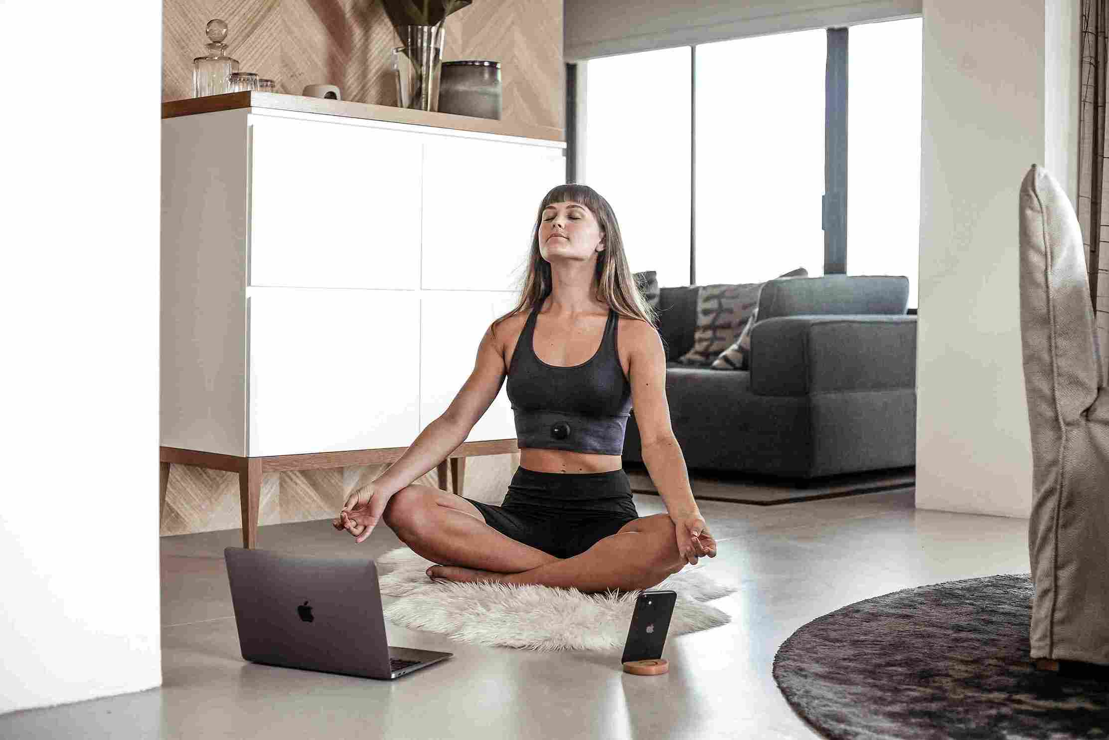 woman in black tank top and black pants doing yoga