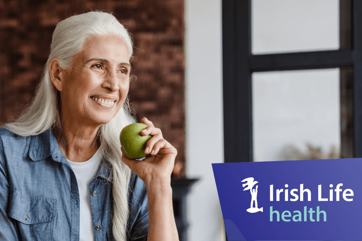 Irish woman with Health Insurance eating an apple