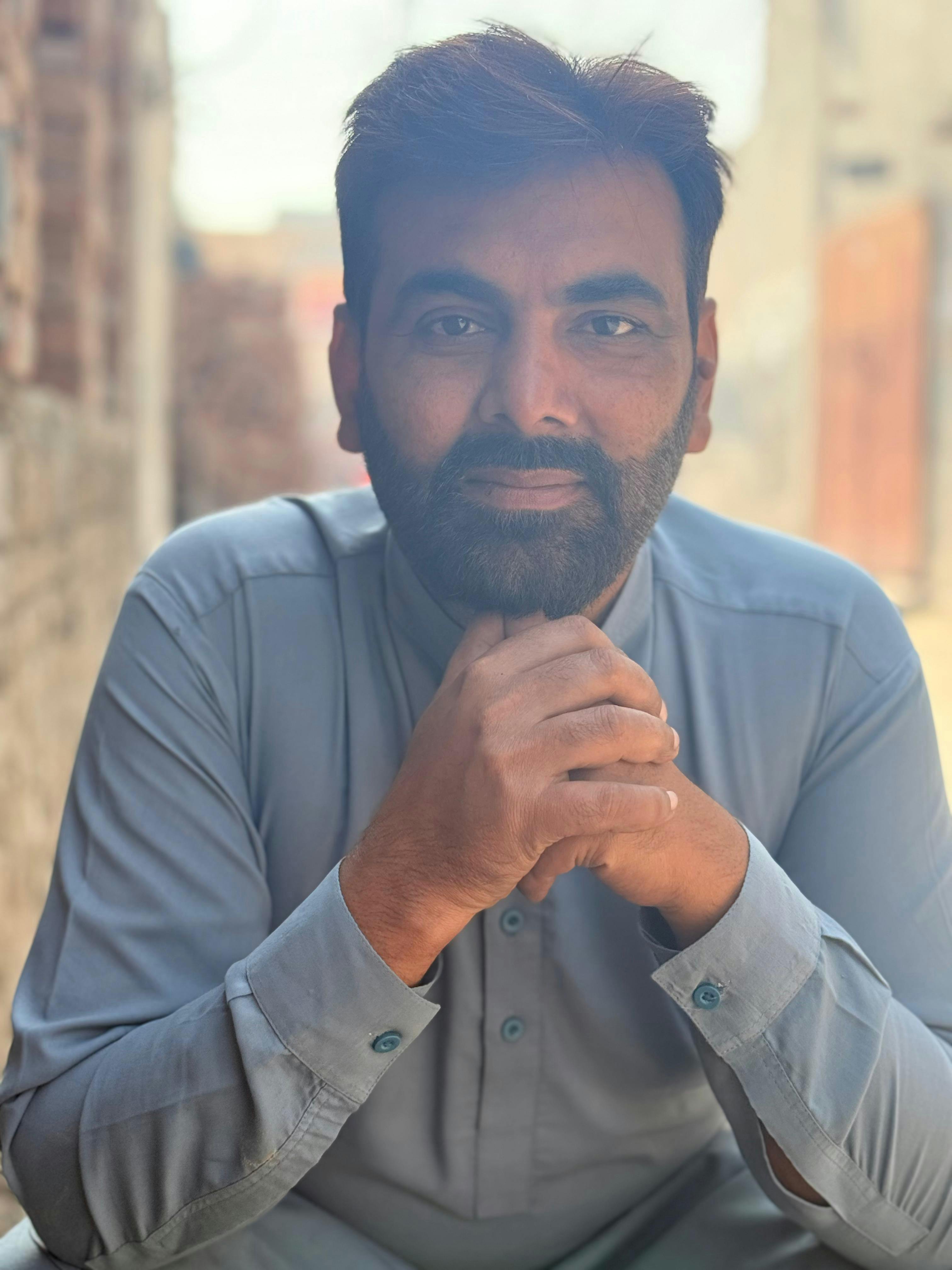a man with a goatee smiles at the camera