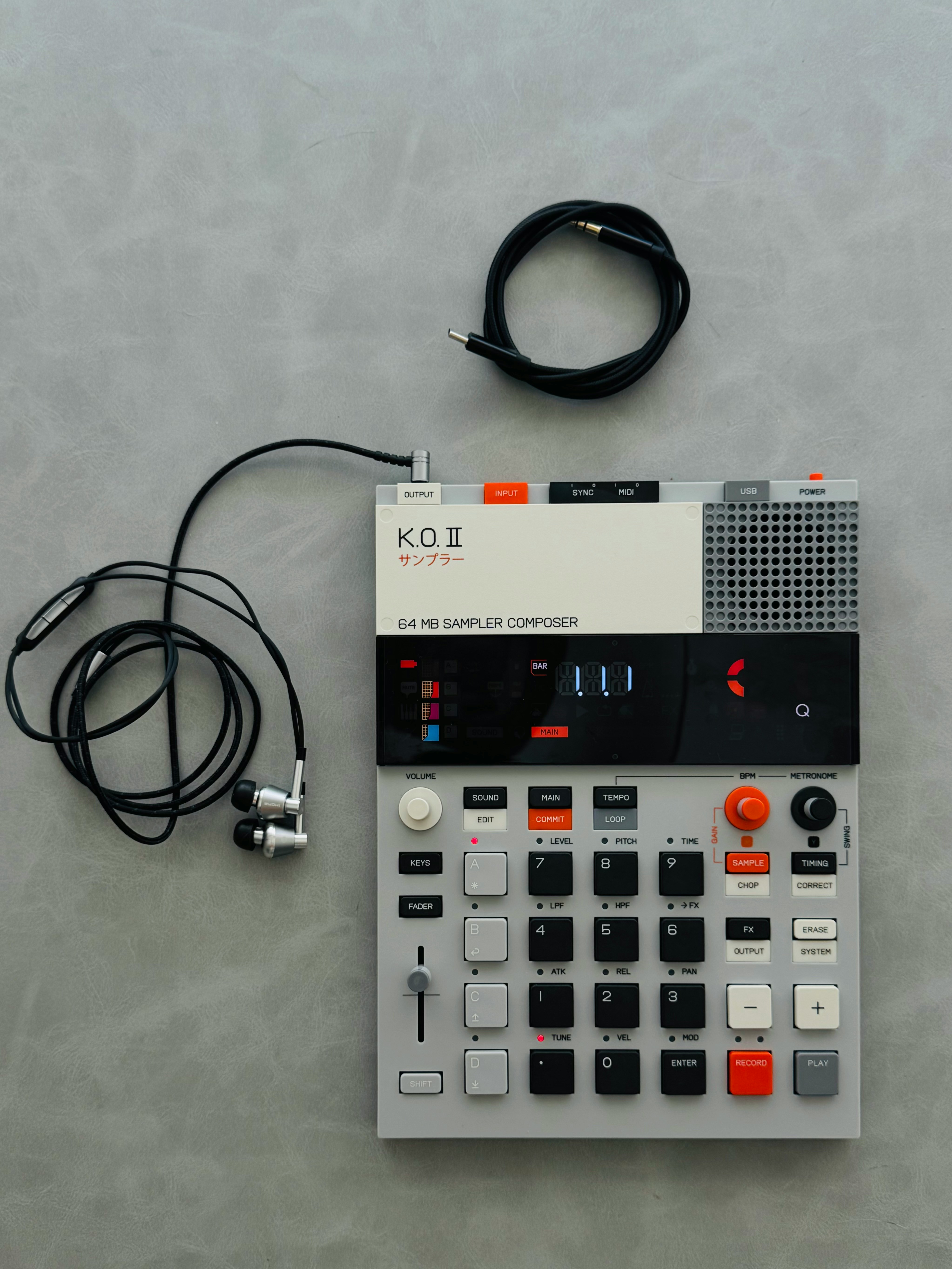 A sampler and headphones on a gray surface