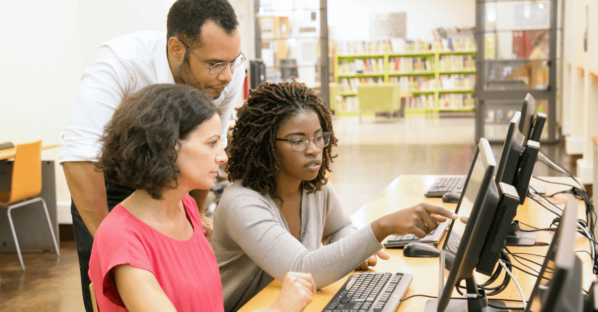 diverse group of people work at computer