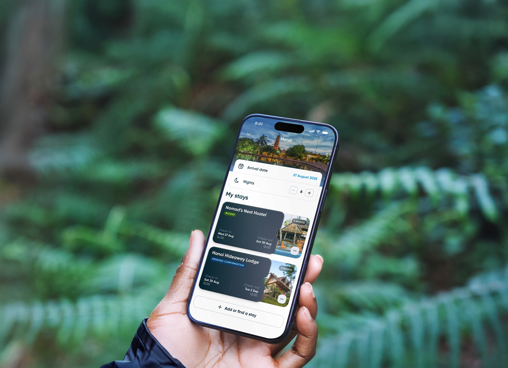 A hand holding a phone against a leafy background. The phone screen shows booking details in the Polarsteps app.