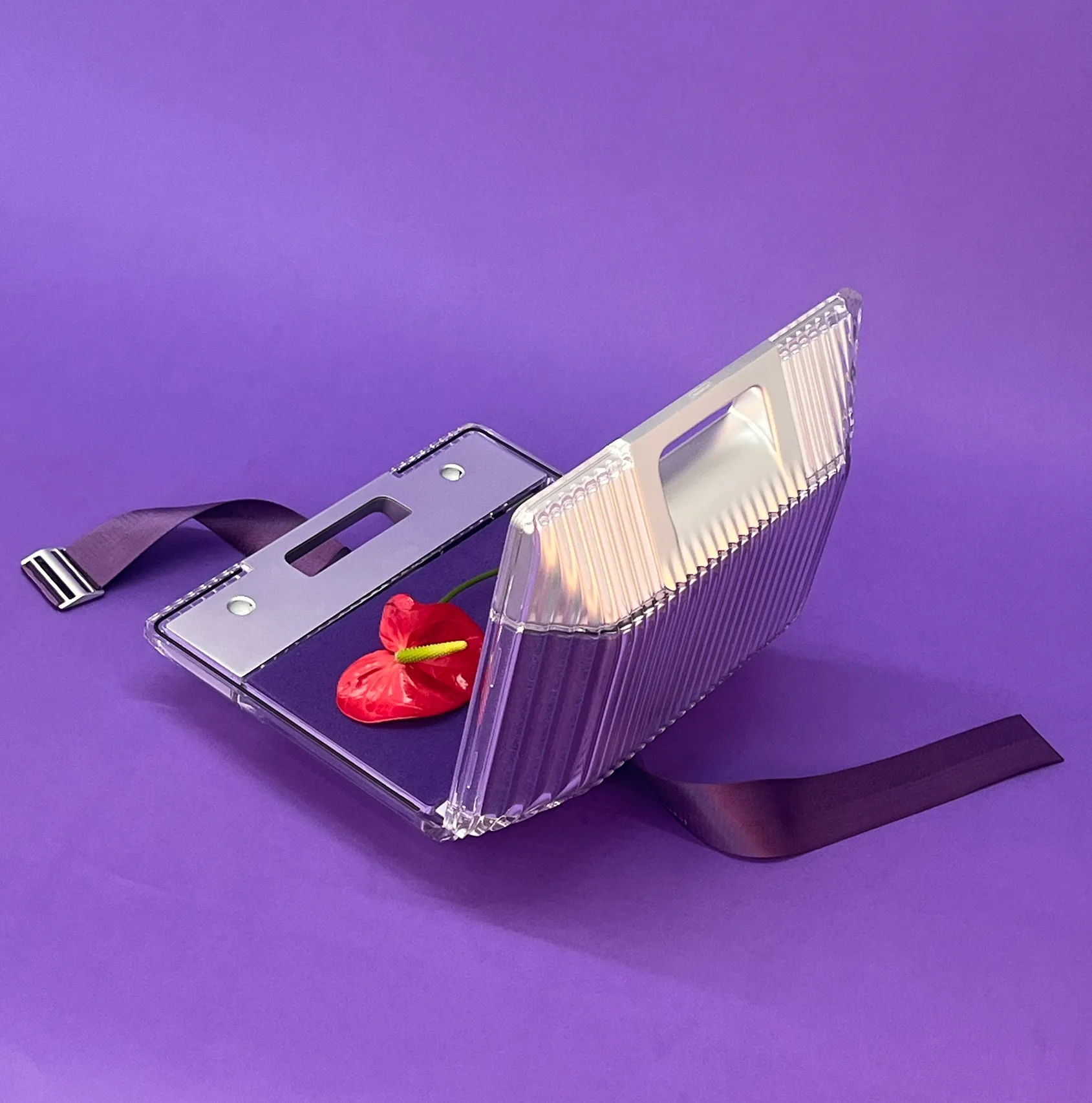 Transparent purple product prototype with straps and red control on a purple background