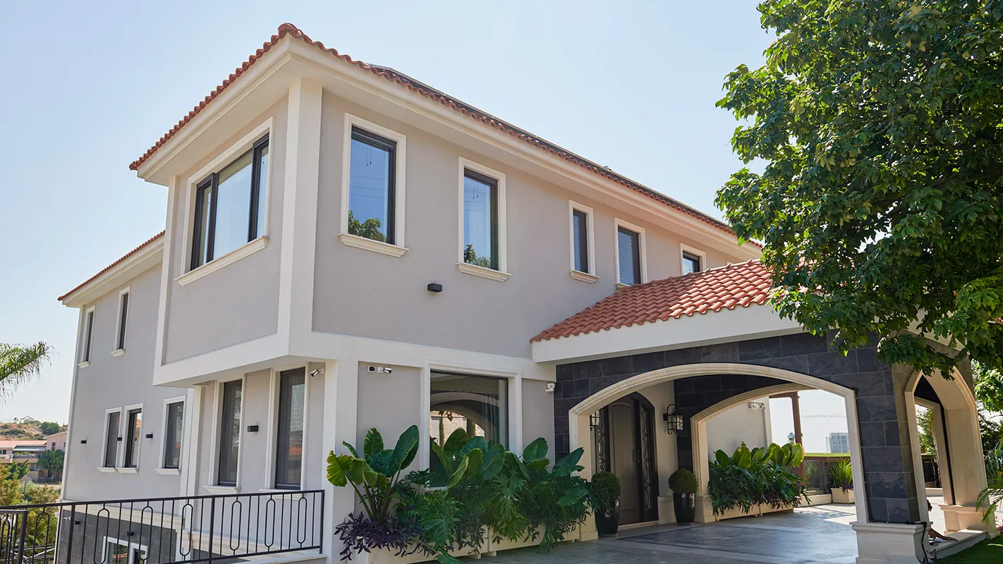 Villa Belmare exterior with Mediterranean-inspired architecture, arched entrance, and terracotta rooflines