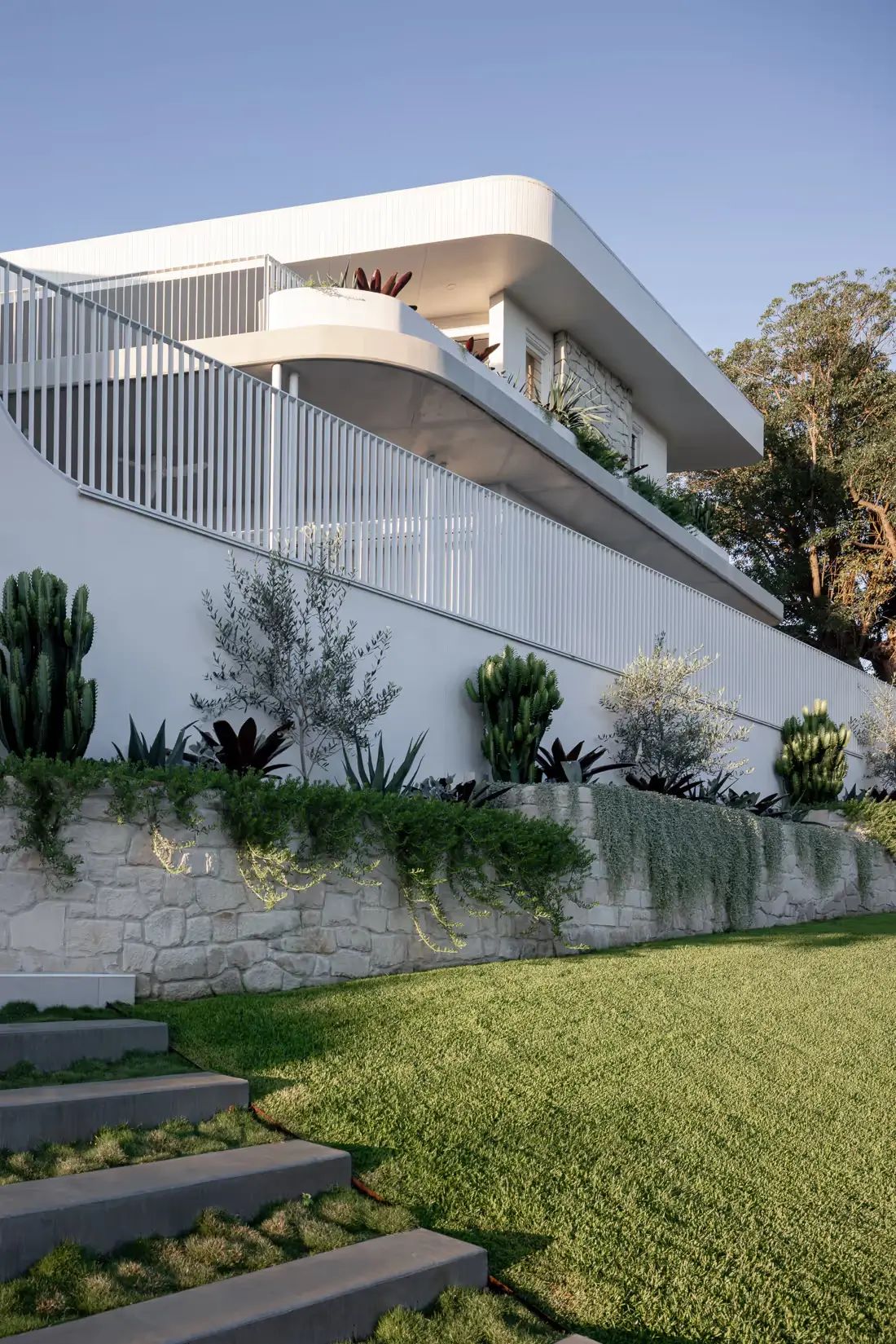 Clare house facade with grass and landscaping