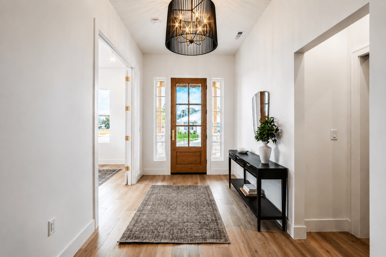 Bright entryway with a wood front door.