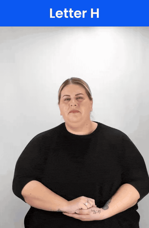 Animated GIF: a Deaf signer signs H in ASL, the index and middle fingers held together and pointing sideways.