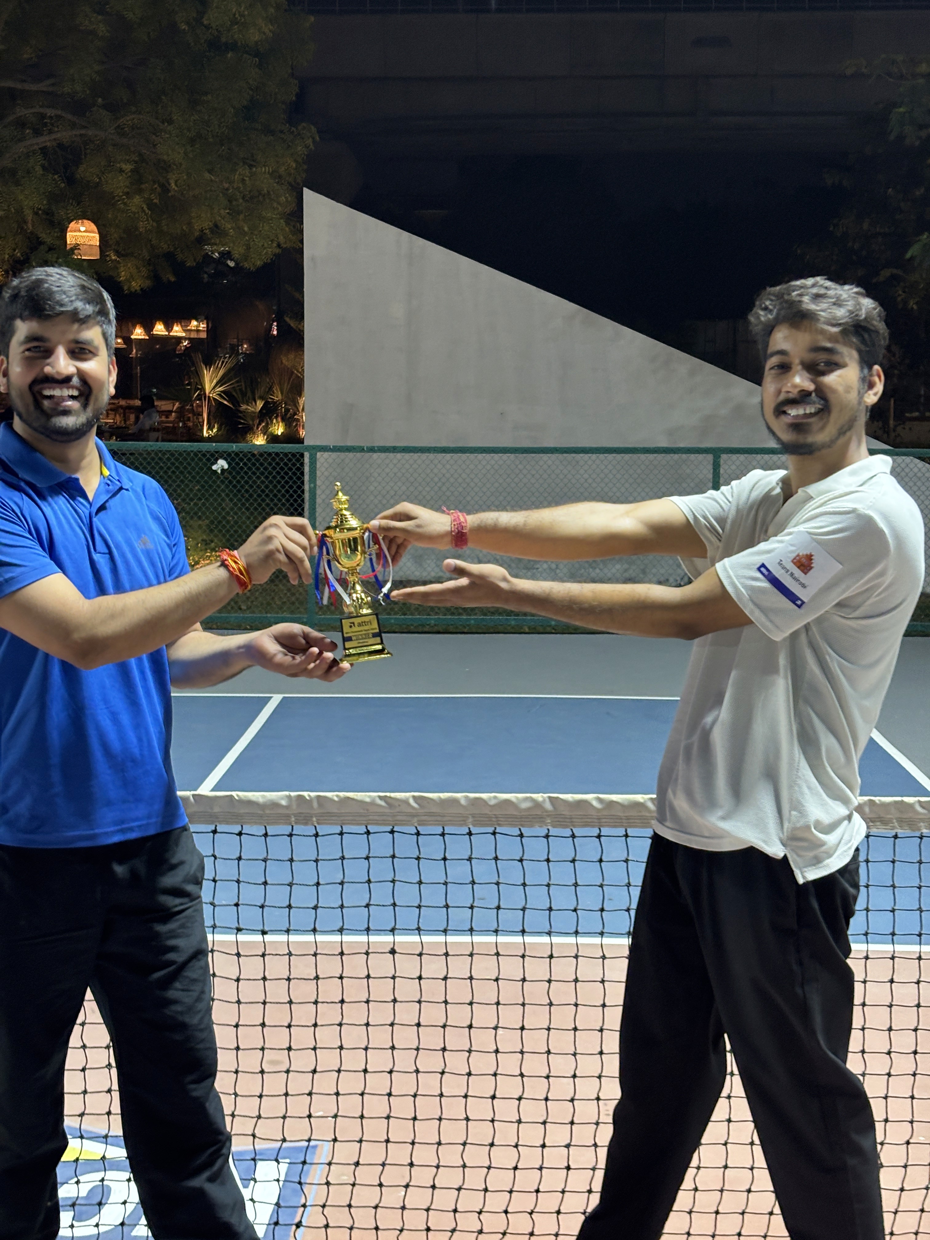 a group of people standing on top of a sandy beach