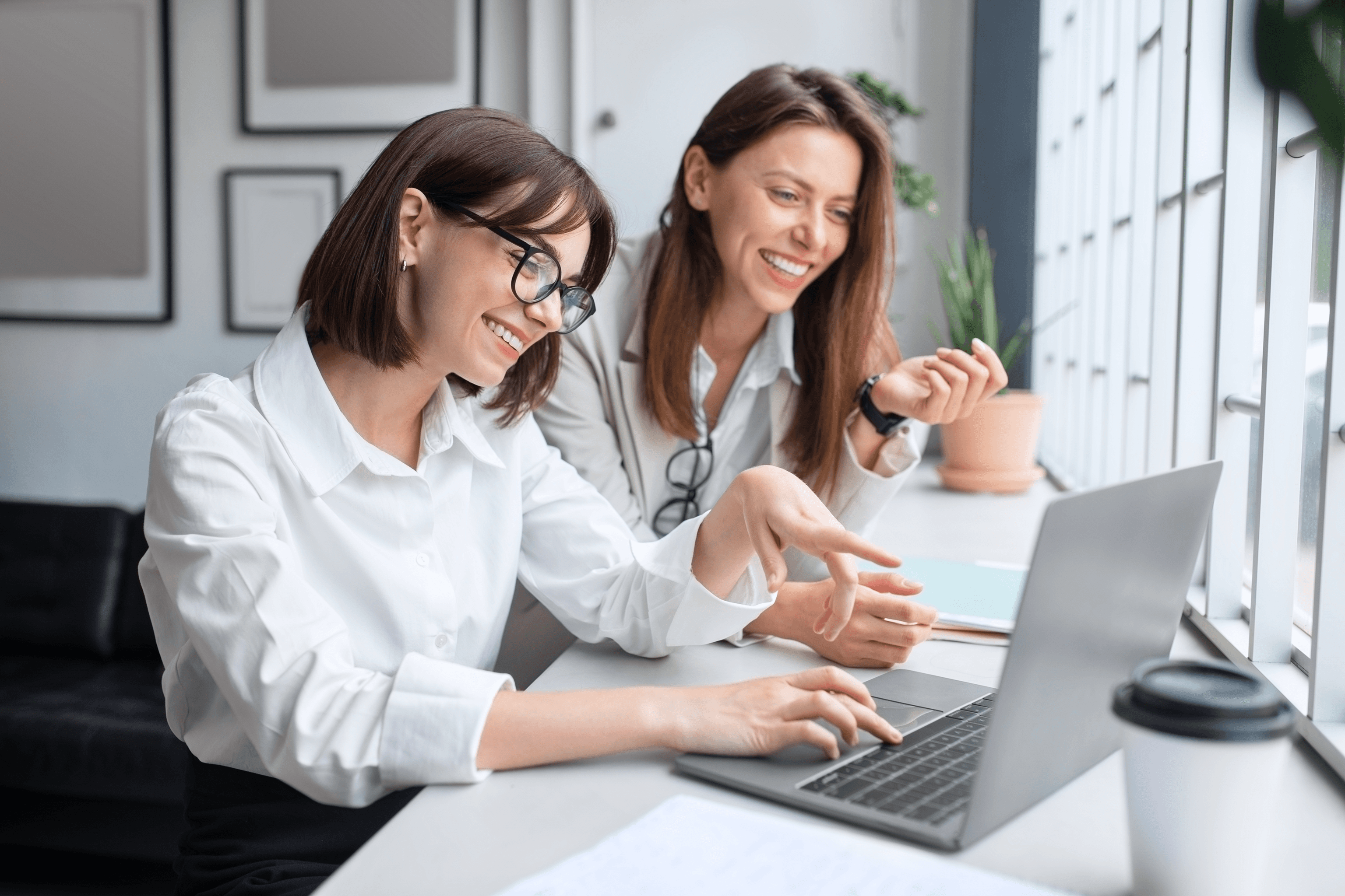 Product team reviewing appointment scheduling software on a laptop, discussing build vs buy requirements and system architecture for healthcare workflows.