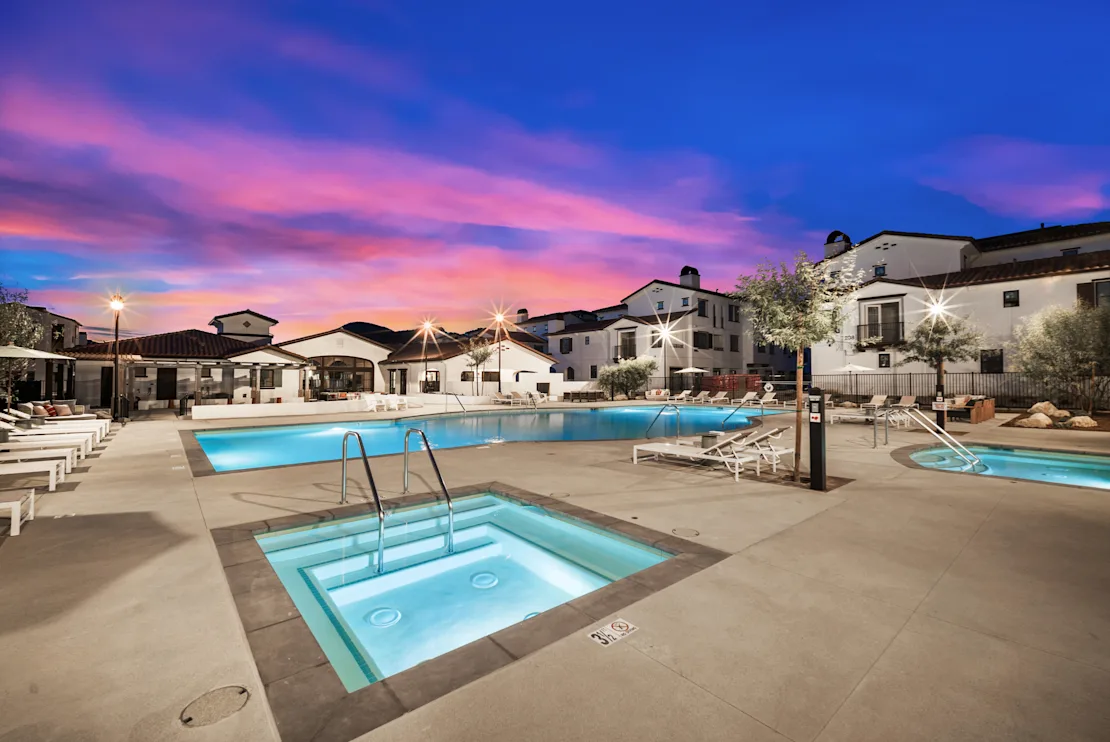 Anacapa Canyon pool and illuminated spas at dusk.