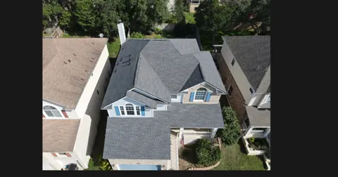 Completed Pewter Grey GAF Timberline HDZ roof on a San Marcos home with blue shutters, 2024.; roof overview used to introduce the installation topic.