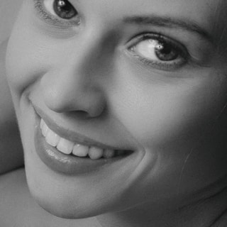 Business professional profile portrait: a black and white photo of a woman smiling