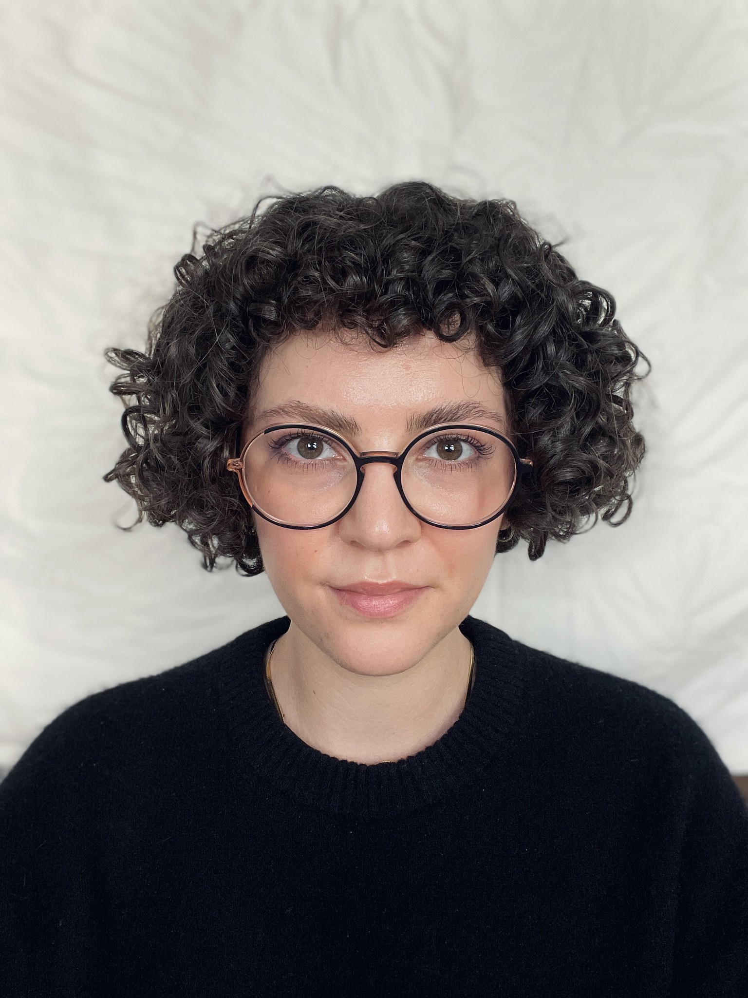A portrait of a young woman slightly smiling