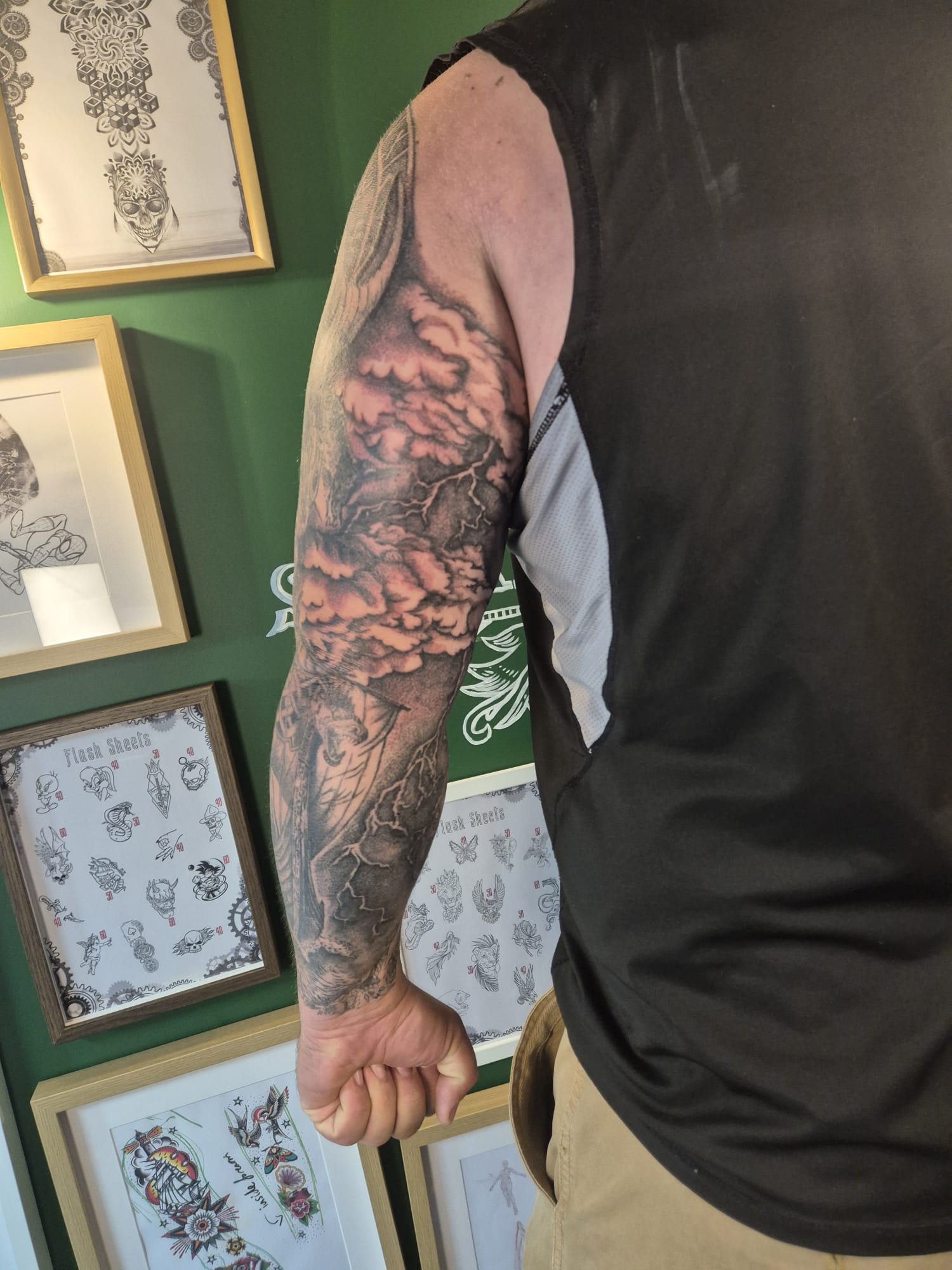 Black and grey arm tattoo sleeve with roses and skull design in Hazel Grove Stockport