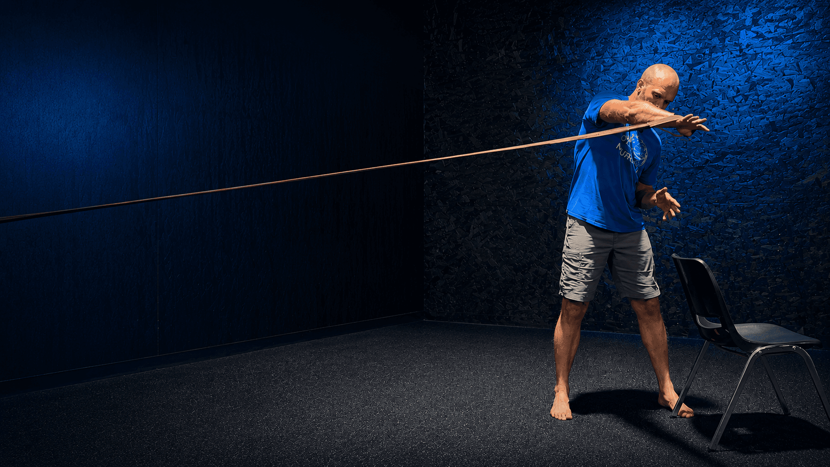 Brian performing a ballistic isometric exercise with a resistance band