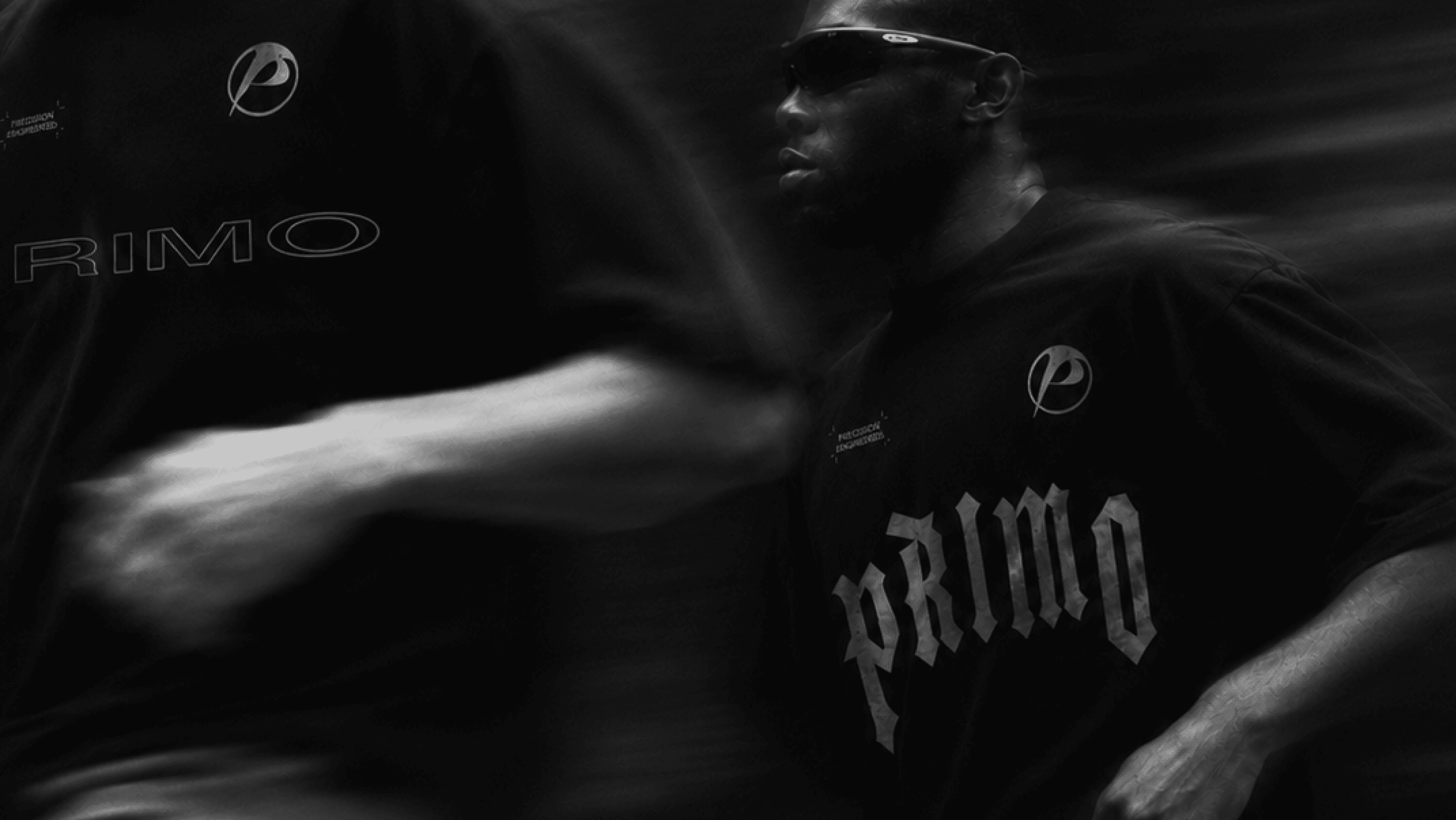 Motion blur of two fighters in Primo Performance Fightwear tees throwing punches