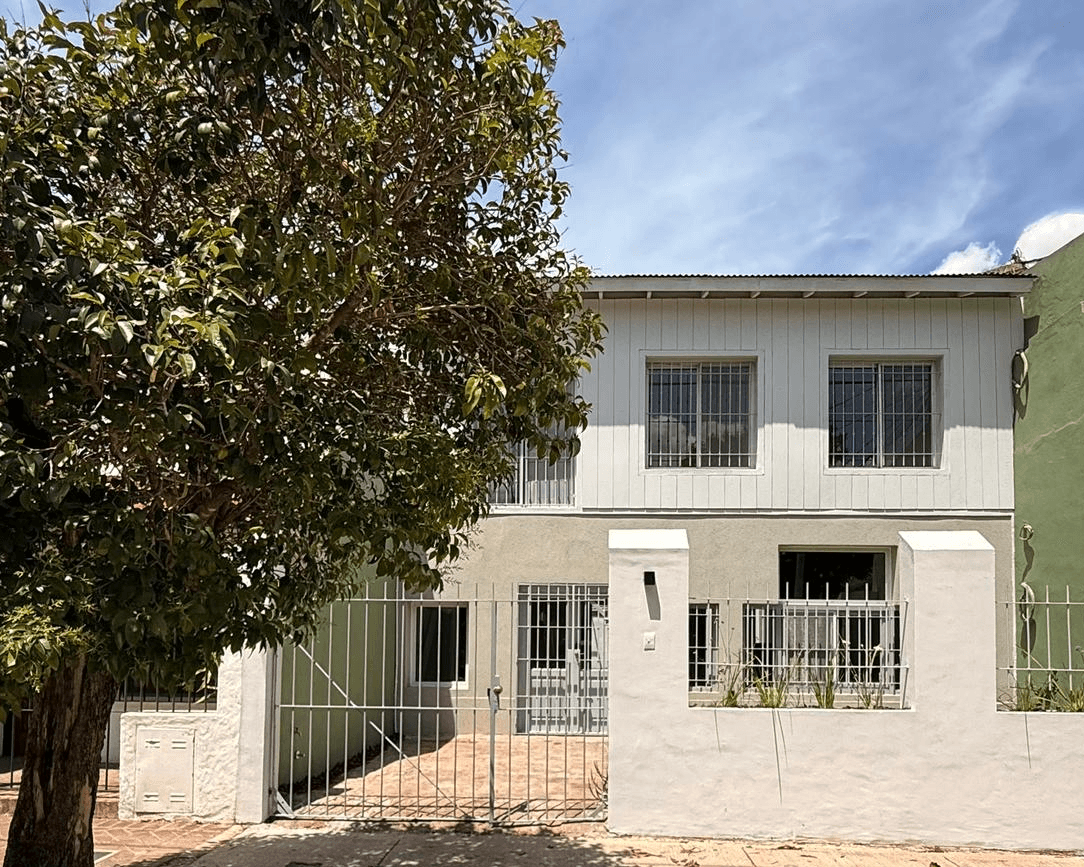 white and brown concrete building near green grass field during daytime