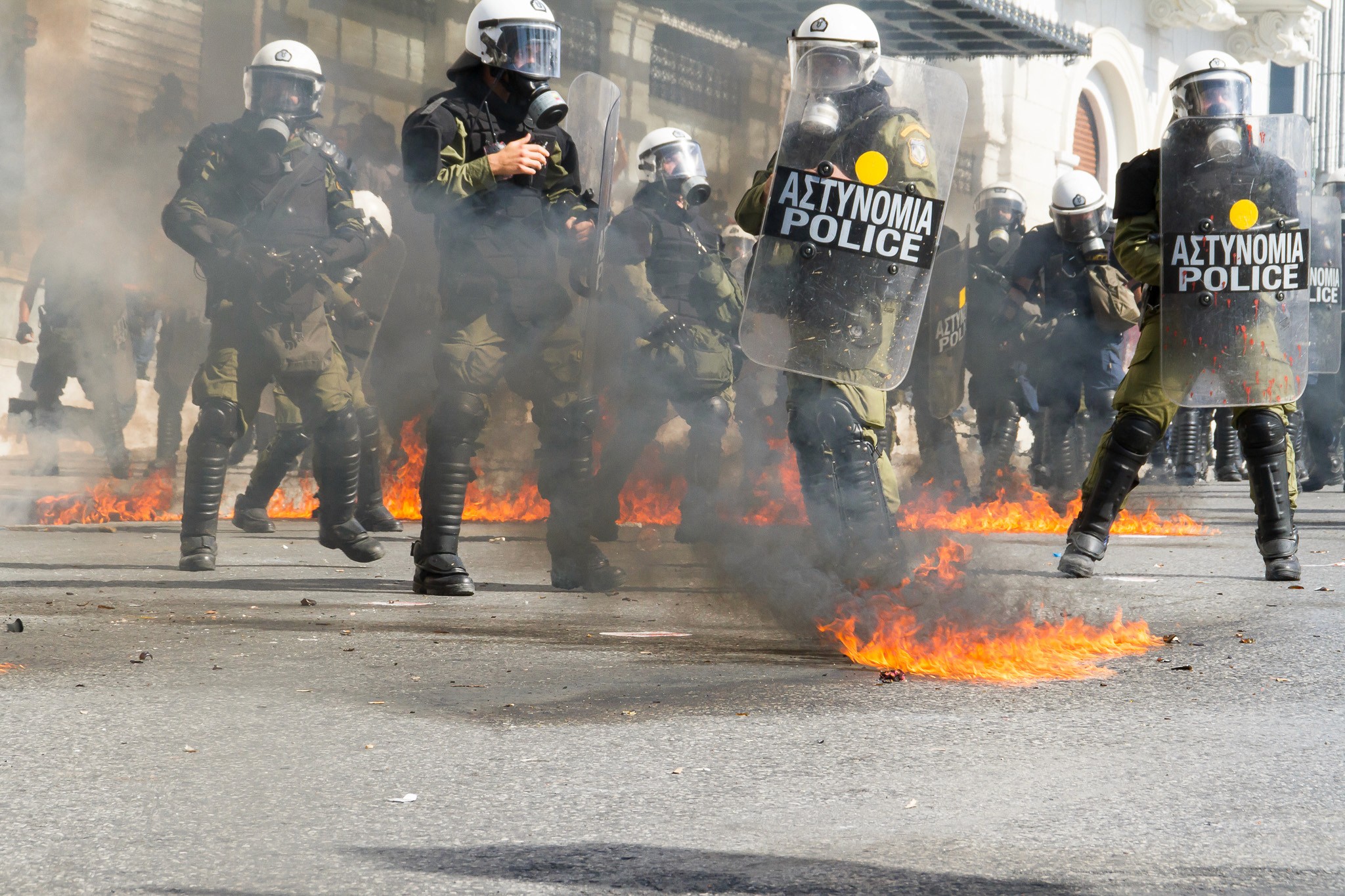 Riots in Athens, a protester is throwing a molotov cocktail. Action Photography, BBC Published