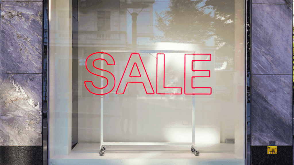 SALE on the front of a store window glass