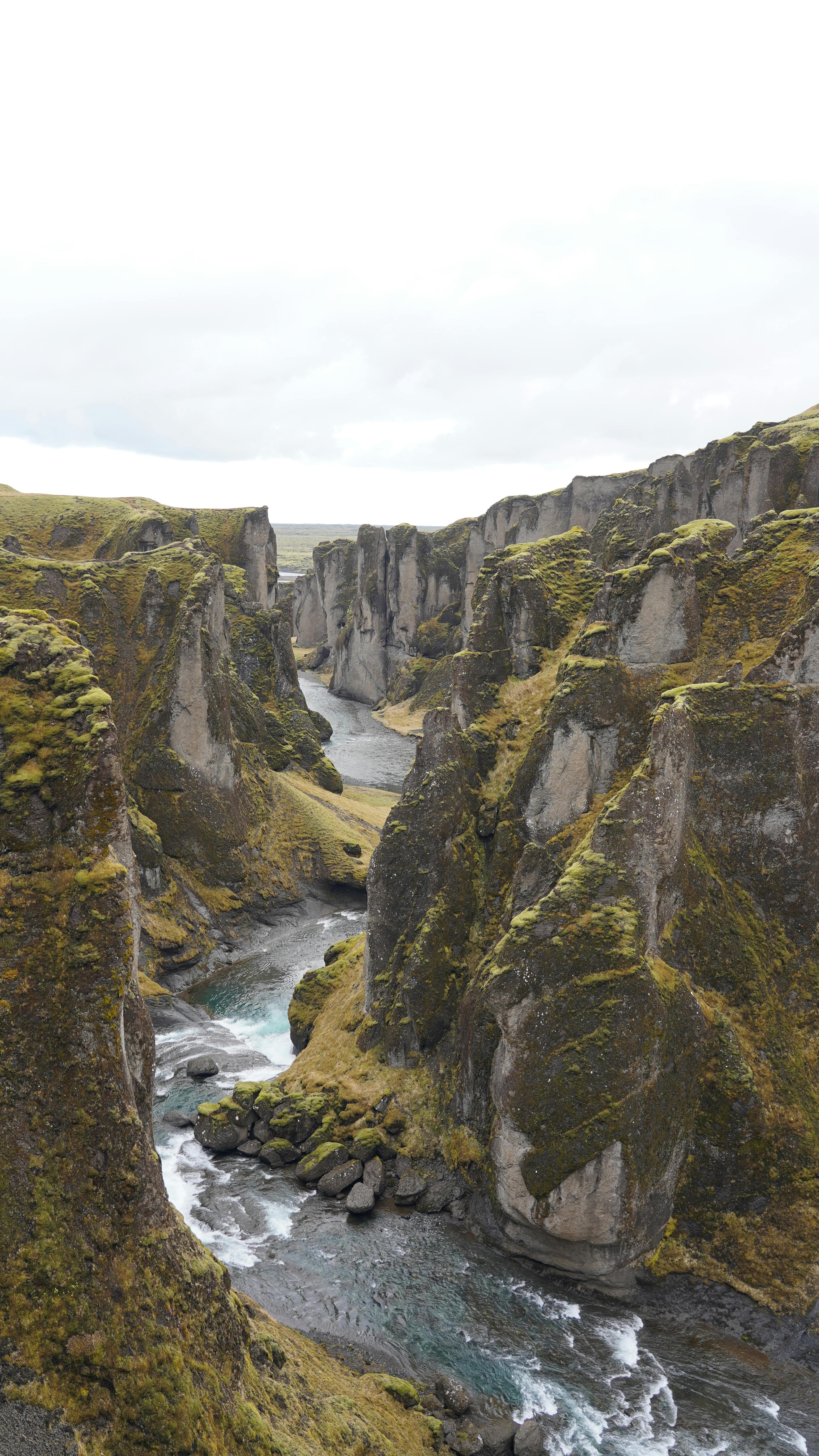 gray pathway between red and black wooden pillar