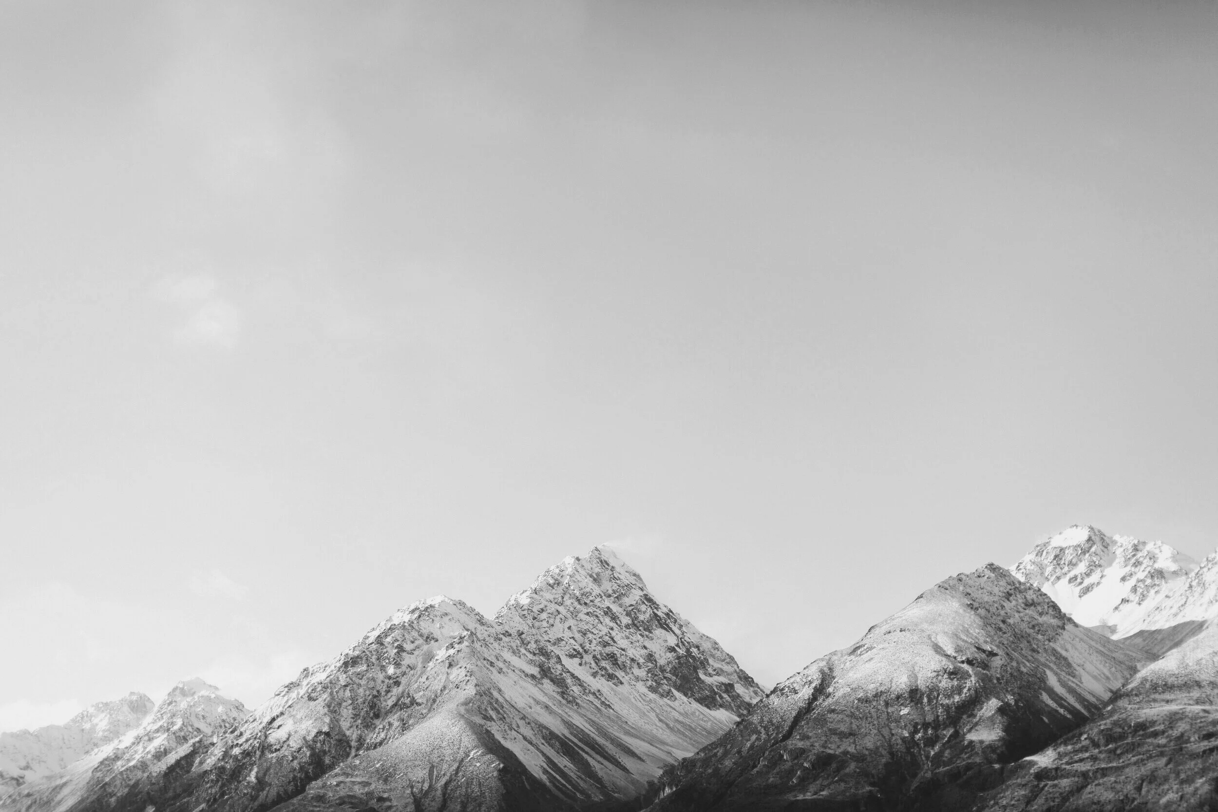 Snow-covered mountain range under an overcast sky