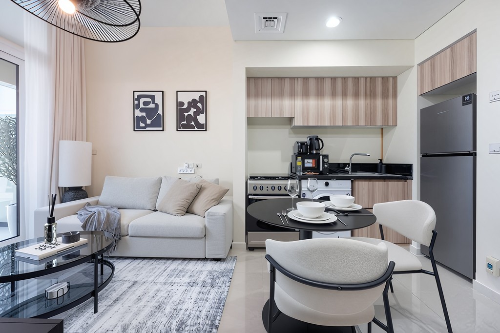 A cozy living room featuring a couch, coffee table, and television, designed for relaxation and entertainment.