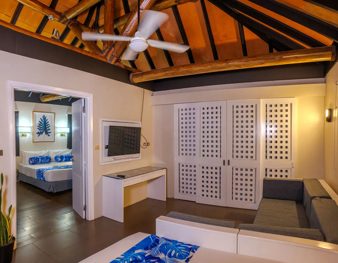 A group in yellow rafts navigates river rapids through a narrow, lush gorge. A Fiji adventure.