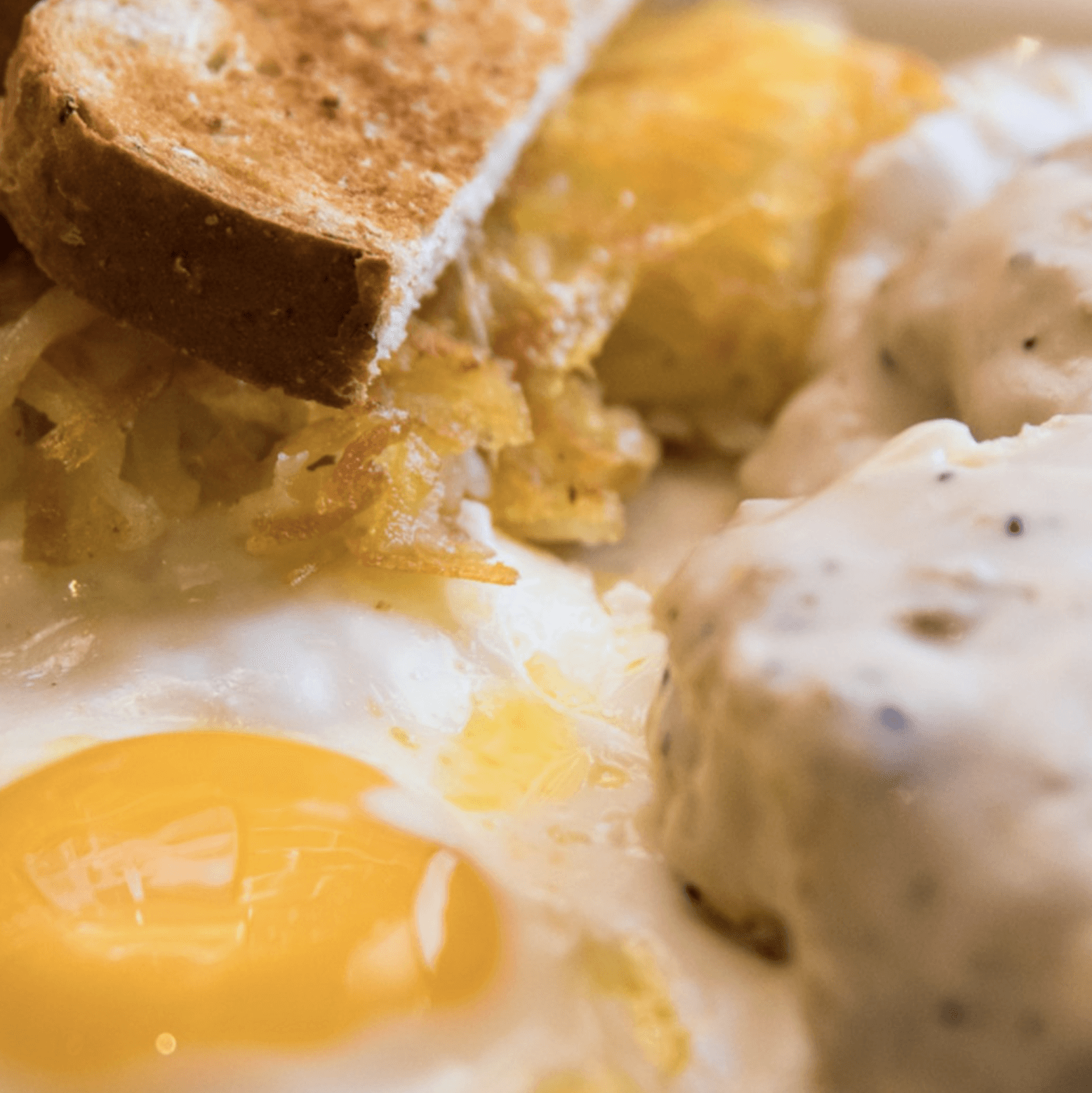 Flaky buttermilk biscuits topped with homemade sausage gravy and a sunny-side-up egg at Engine House Cafe.