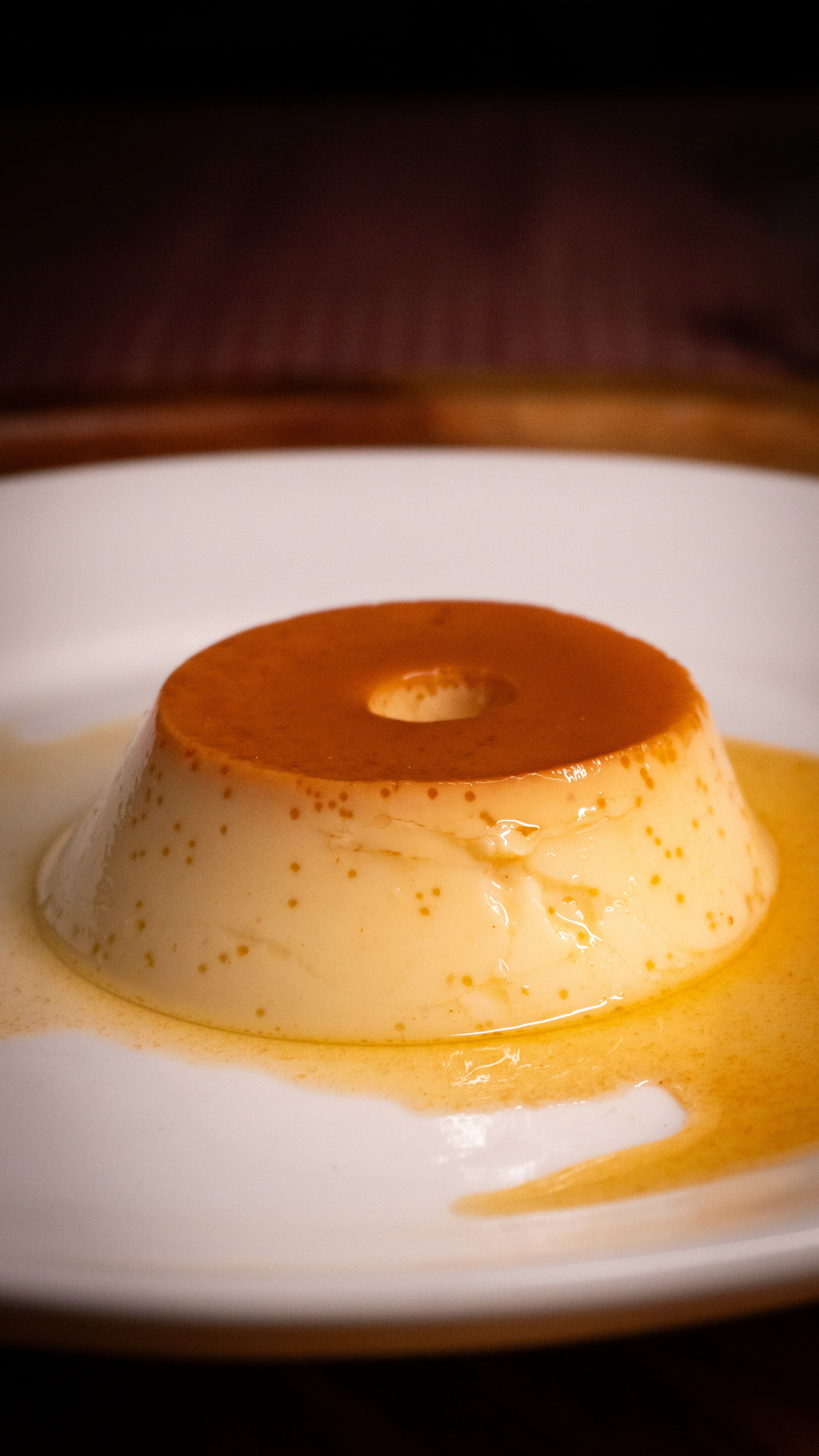 Full moon rising over a dark, silhouetted mountain ridge.