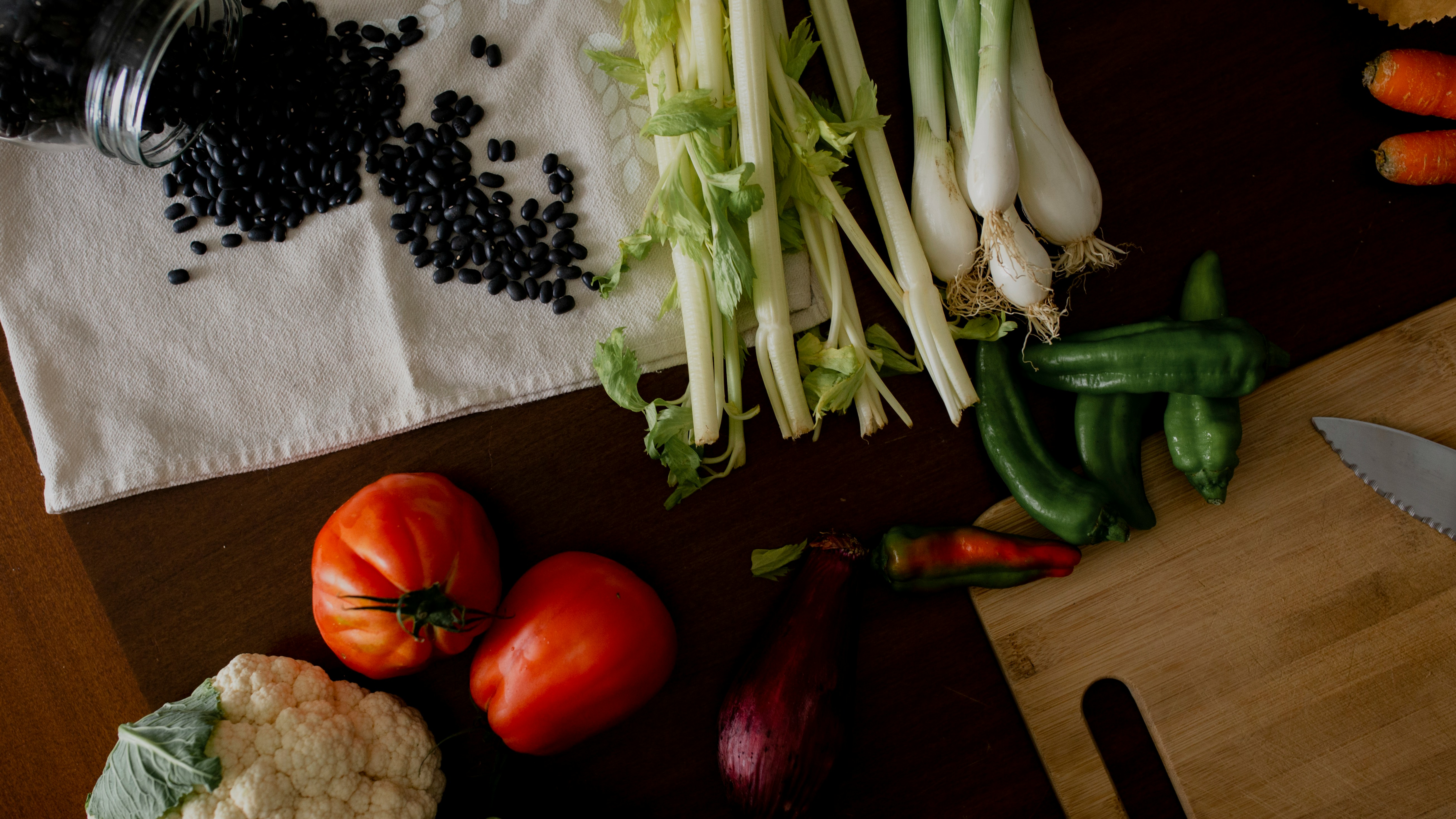 red tomato beside green vegetable