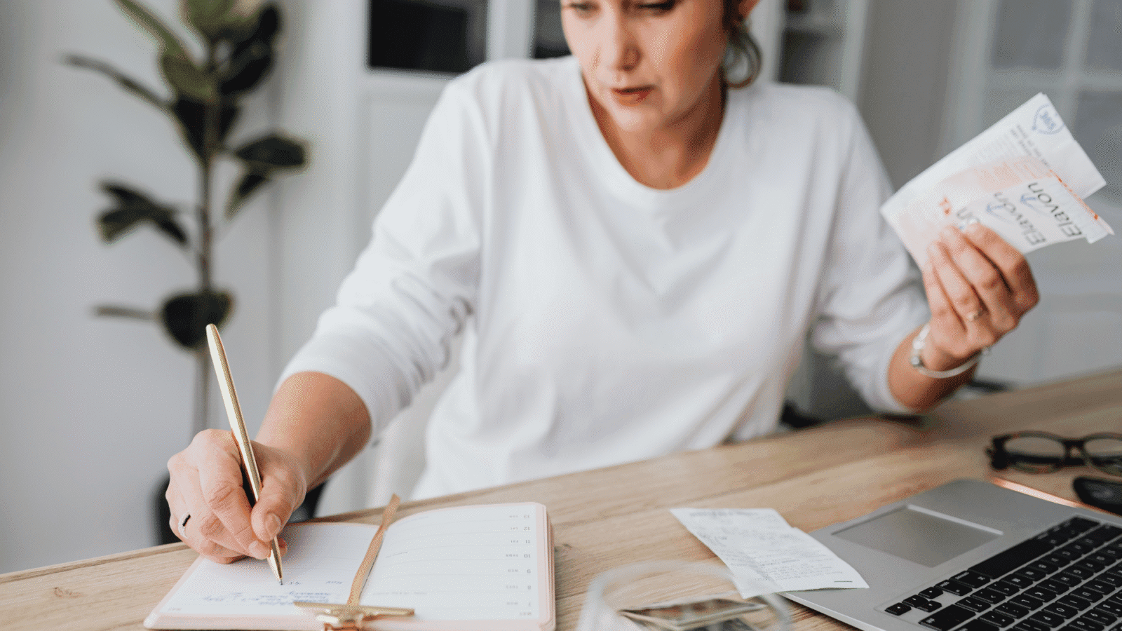 Woman calculating expenses - How to Categorize Small Business Expenses